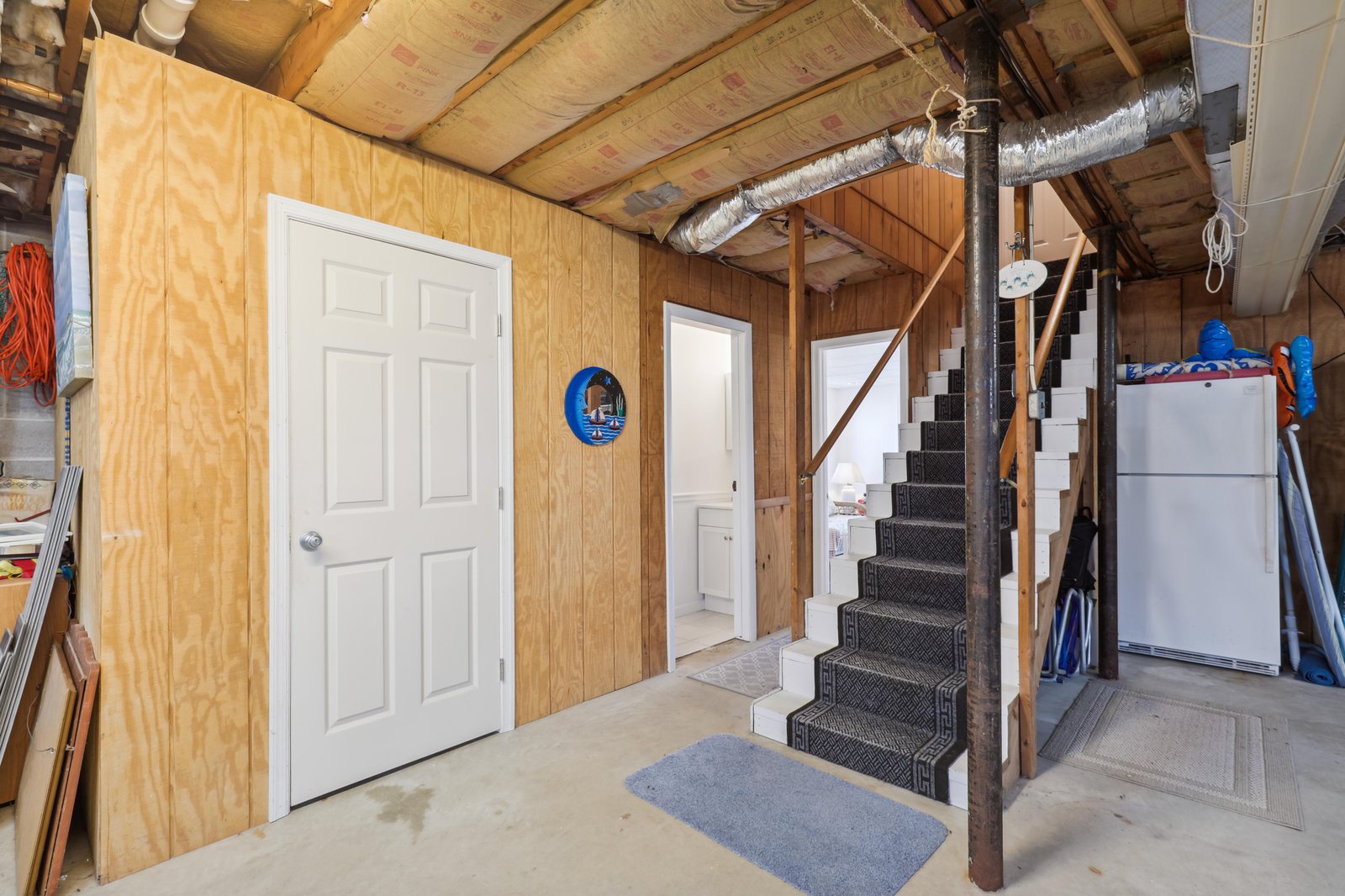 A private entrance area with carpeted stairs leading to your living space, providing secure access and functional storage for outdoor gear and essentials.