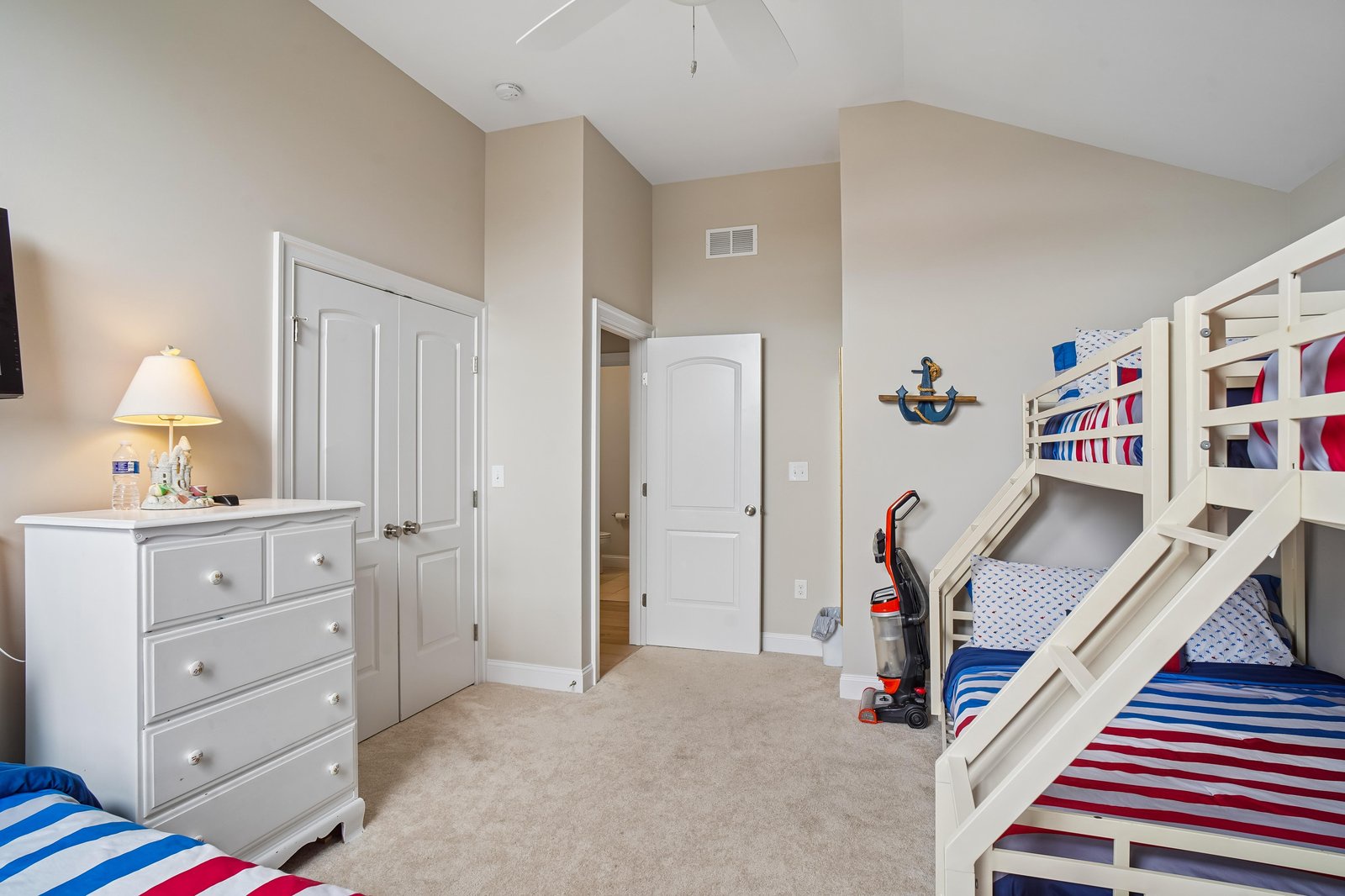 The kids will love this cheerful bedroom with its nautical-themed bunk beds and plenty of space to play and unwind after your adventures.