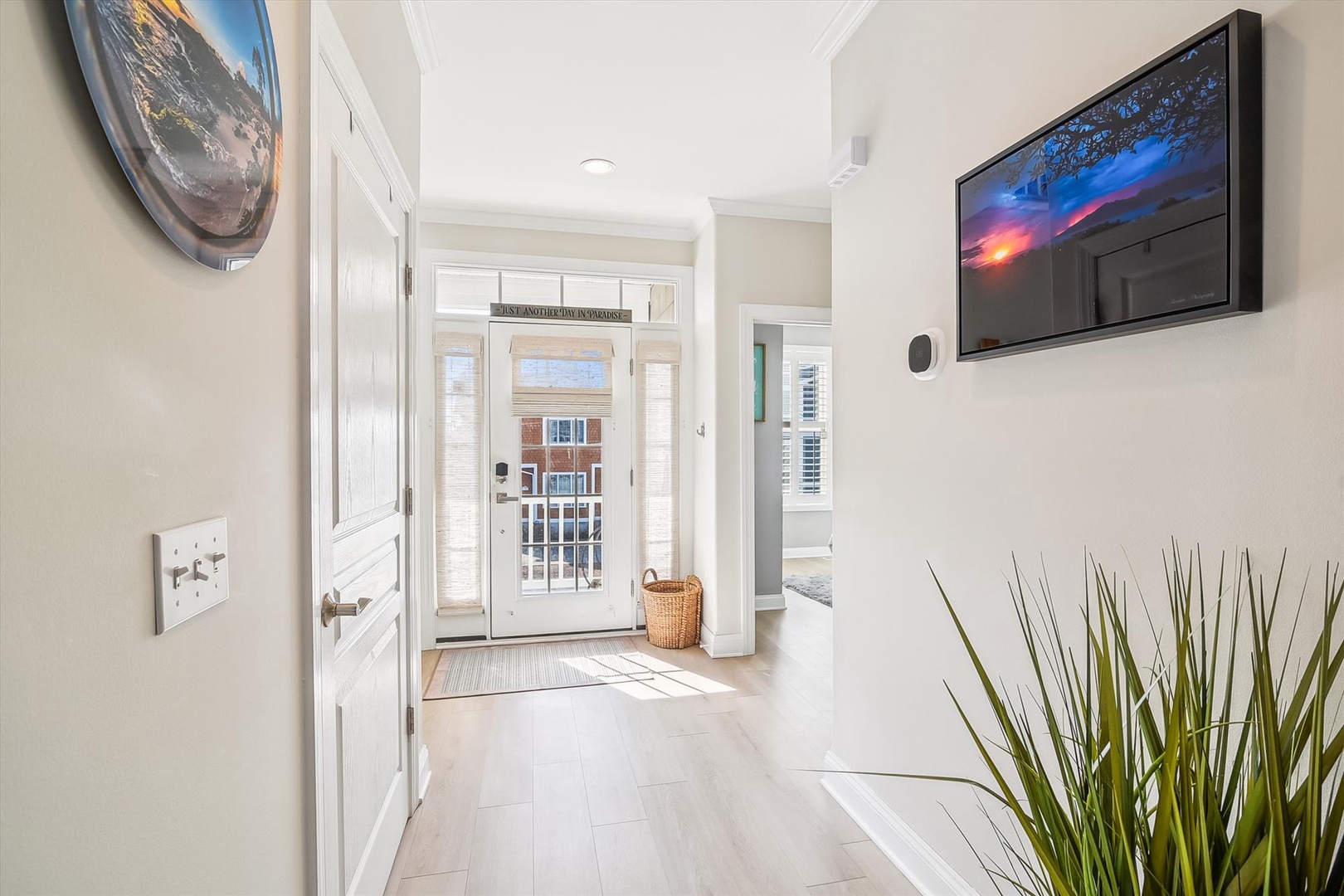 Step into your bright, welcoming entryway with soaring ceilings and natural light streaming through elegant glass doors.