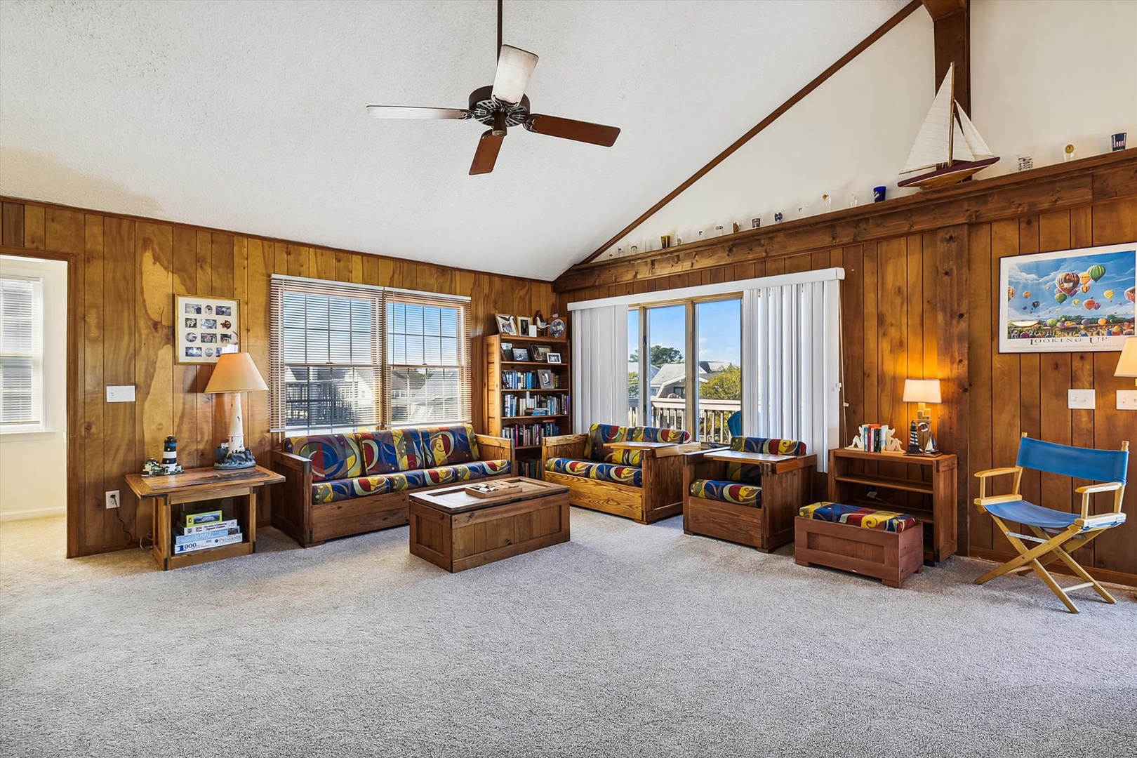 Step into your cozy living space with warm wood-paneled walls, bright natural light, and comfortable seating perfect for relaxing after a day of adventure.