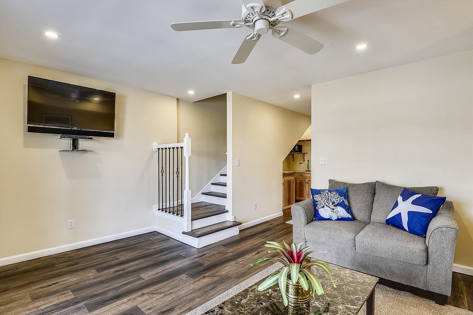 Relax in your bright, spacious living area with cozy seating, ceiling fan, and TV—perfect for unwinding after your adventures.
