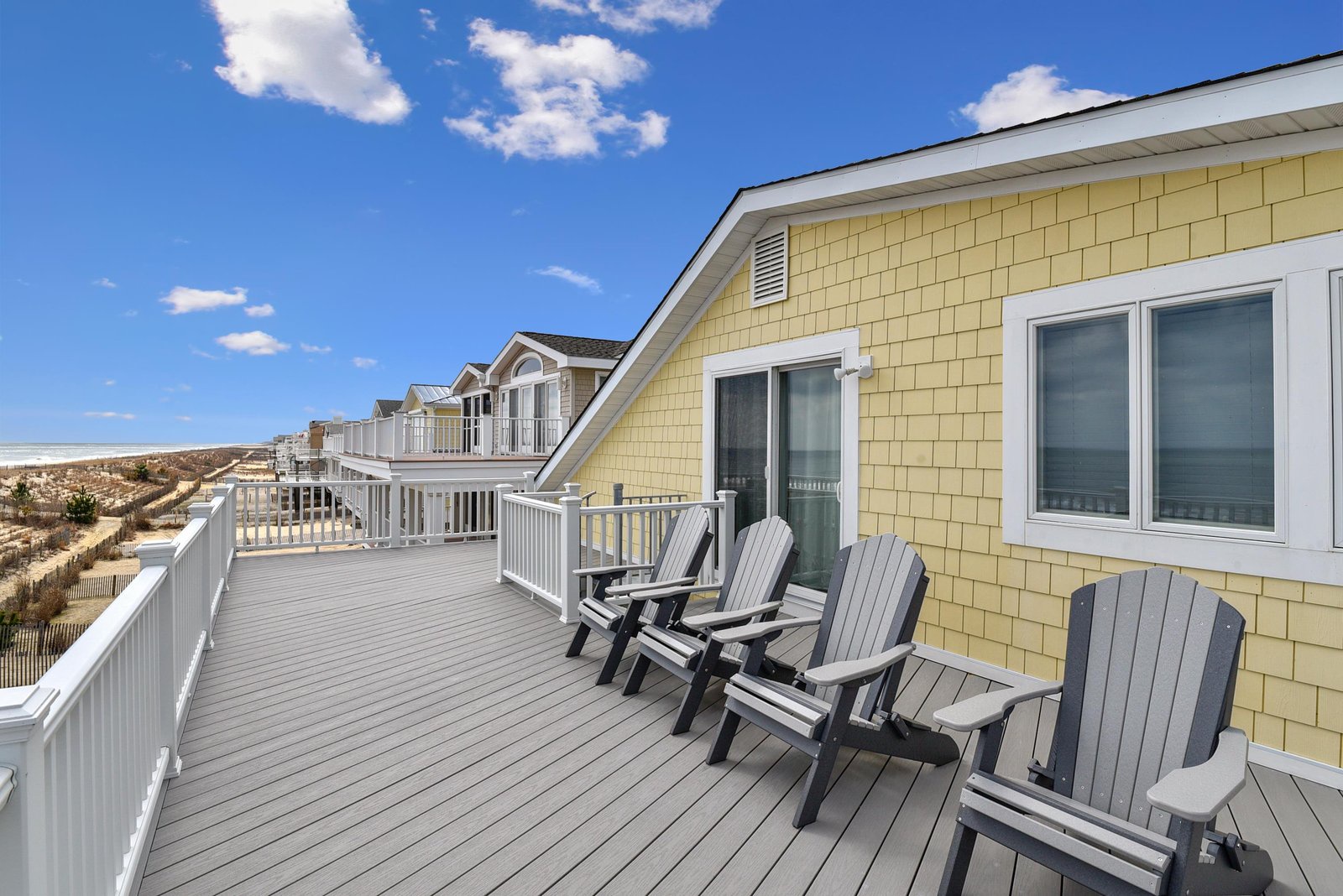 Stretch out on your expansive deck, where Adirondack chairs await and ocean breezes sweep in under wide blue skies.