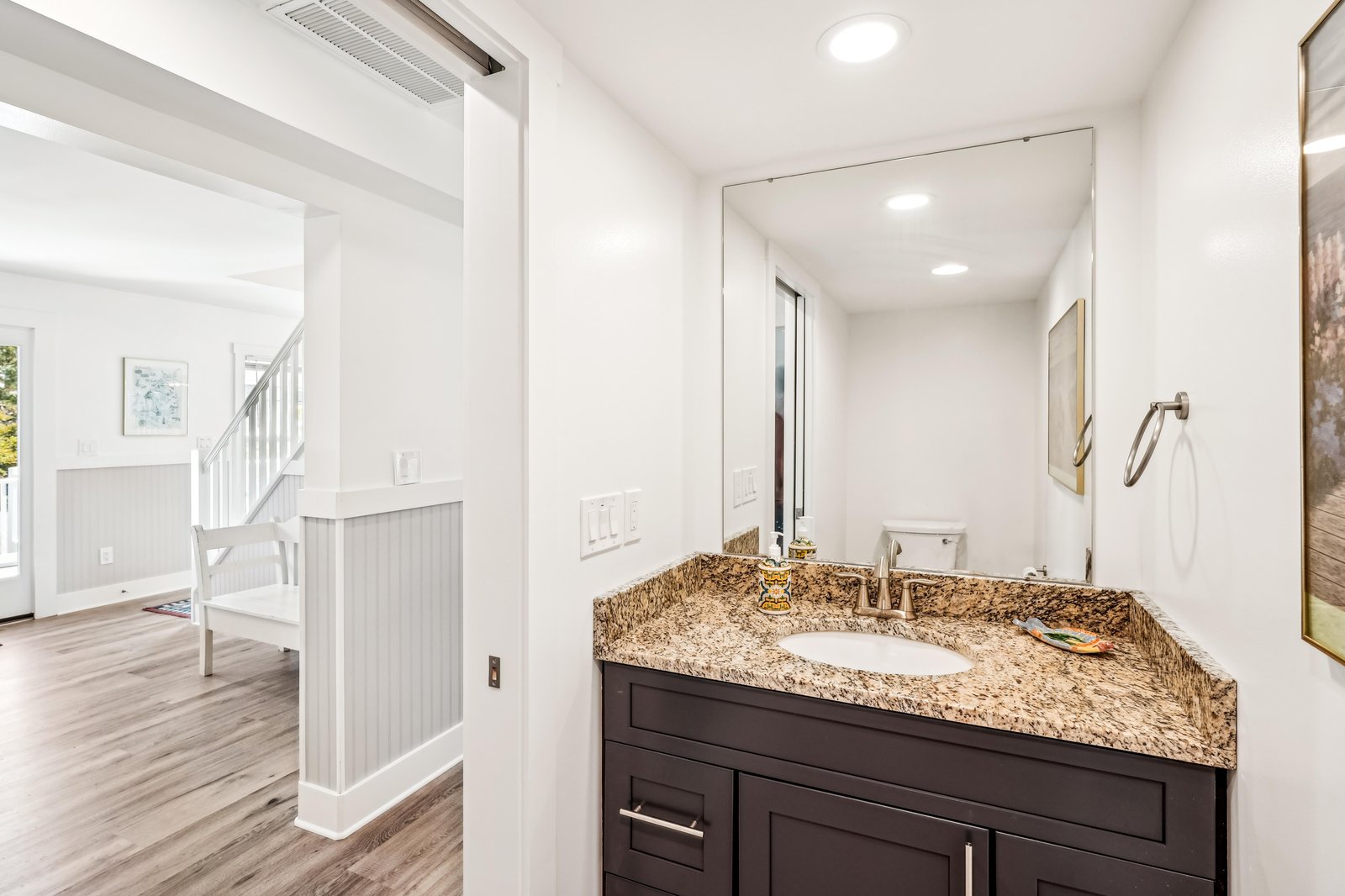 Step into your private bathroom featuring a polished granite vanity, sleek modern fixtures, and thoughtful lighting—making your morning routine feel spa-like and special.