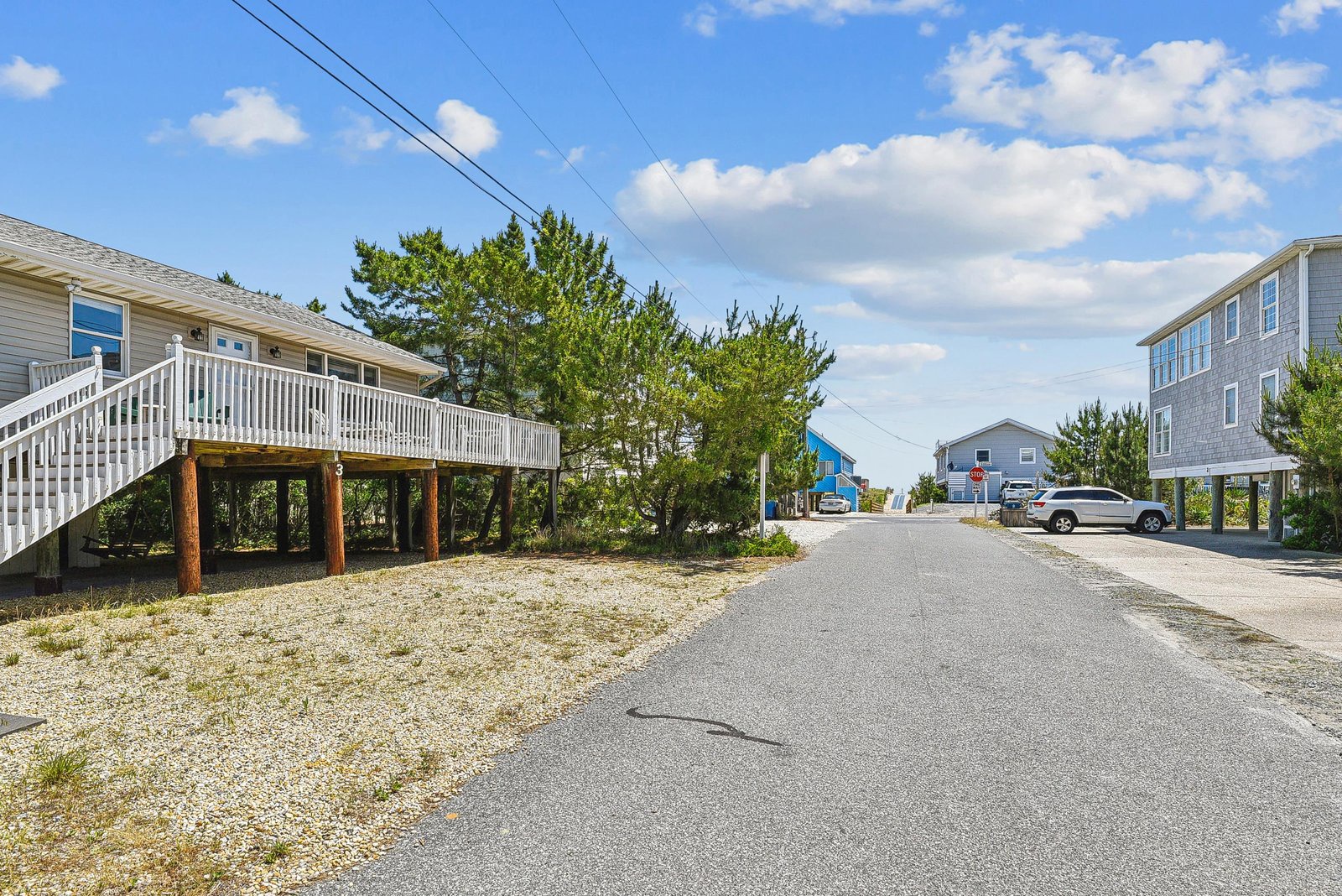 The property is nestled in a quiet coastal neighborhood, with beach homes lining the peaceful street leading to your getaway.