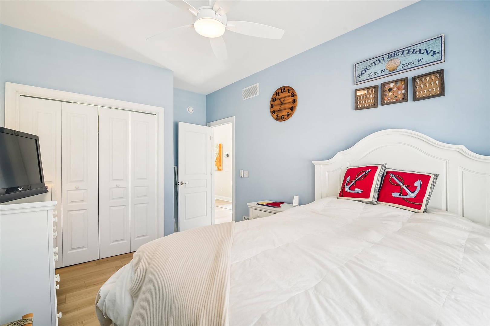 Unwind in your serene coastal-themed bedroom with nautical touches, soft blue walls, and a comfortable bed that invites peaceful sleep after your beach adventures.