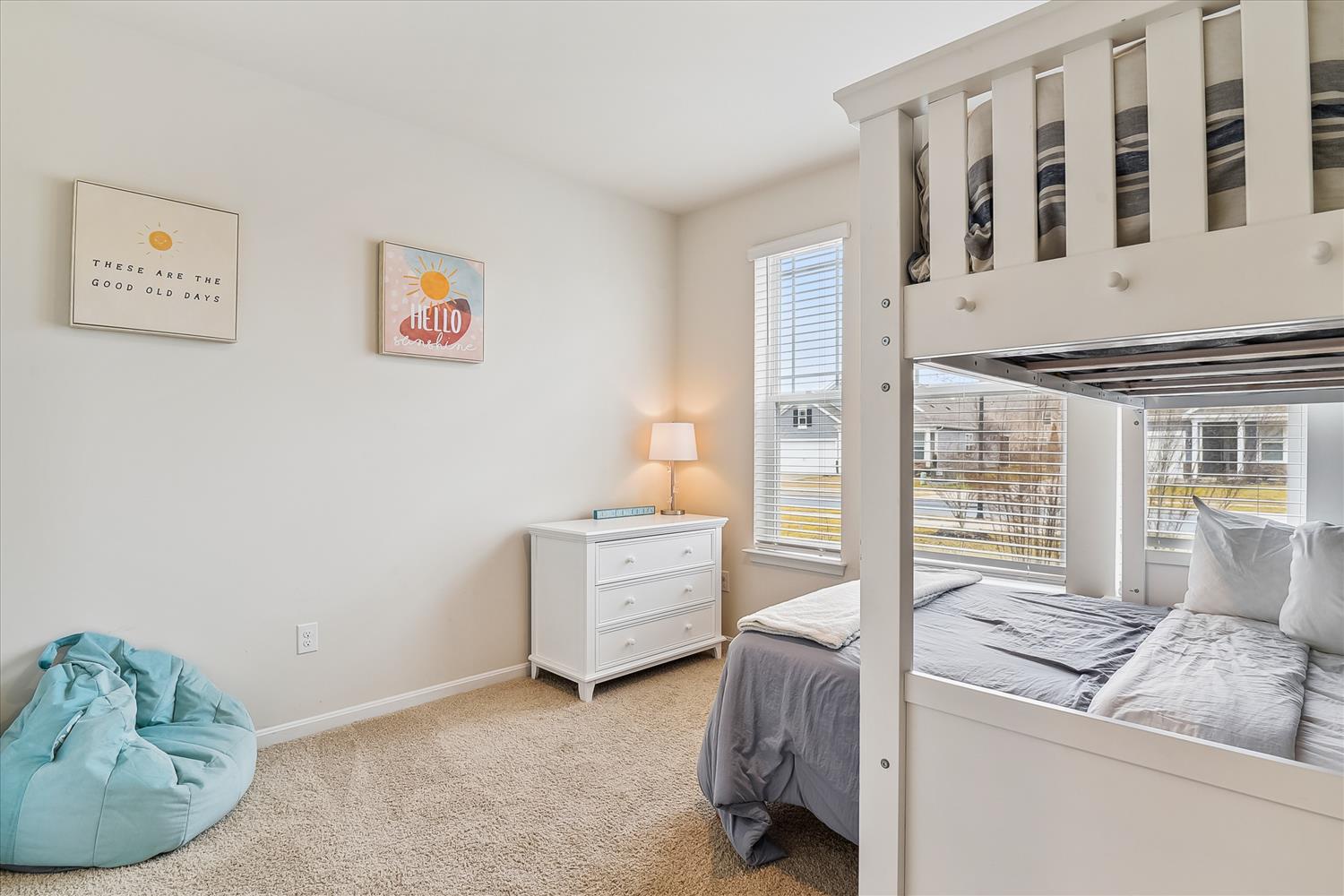 Your kids will love this cozy bedroom with fun bunk beds, soft bean bag seating, and cheerful artwork creating the perfect space for rest and play.