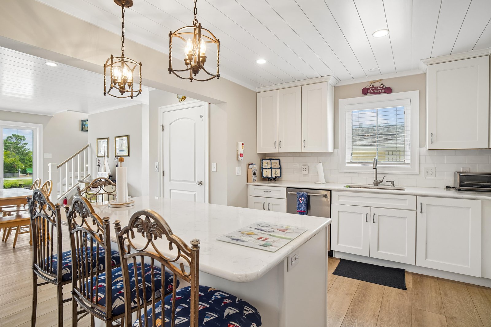 Step into your bright, open-plan kitchen and dining area where coastal charm meets modern convenience. White cabinetry, stainless appliances, and a center island invite you to gather, cook, and linger over meals with loved ones.