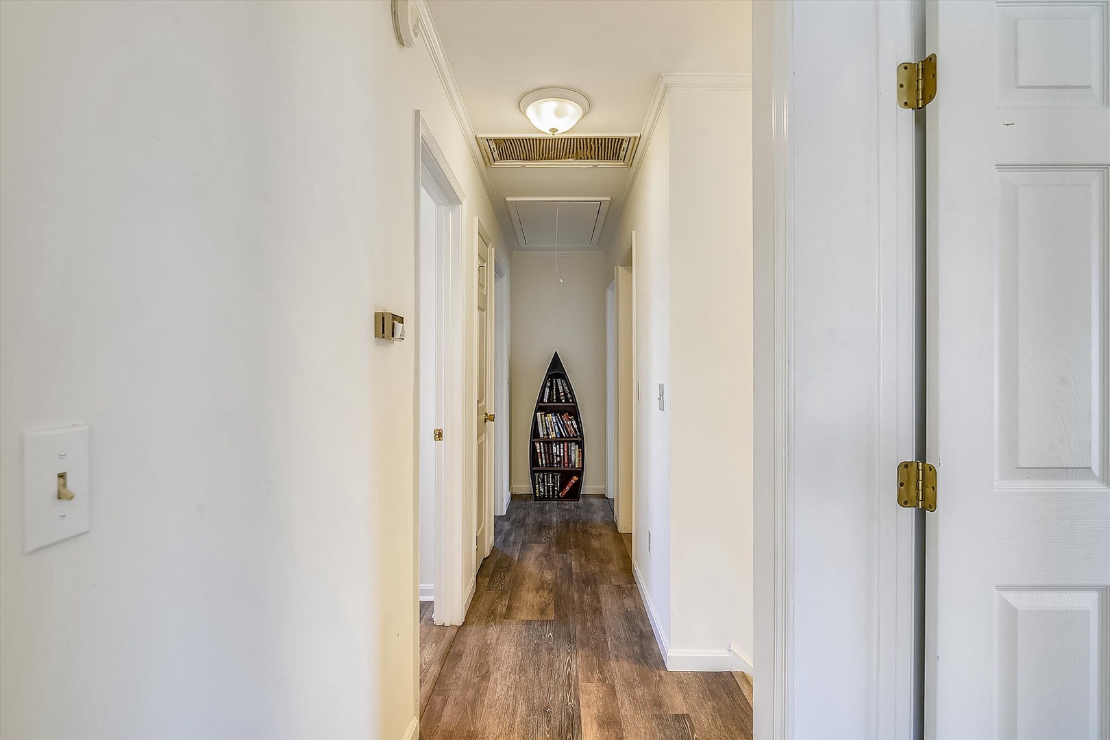 The bright hallway with charming nautical touches connects your private spaces, making every corner of the home feel accessible and inviting.