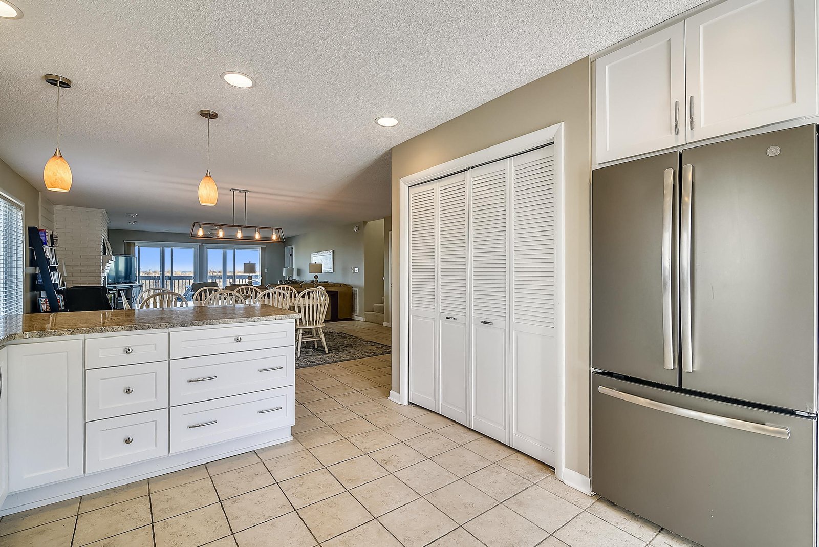 Step into a bright, fully-equipped kitchen with modern appliances, granite counters, and an open layout that flows into the dining and living areas—your home base for vacation mornings and easy coastal living.