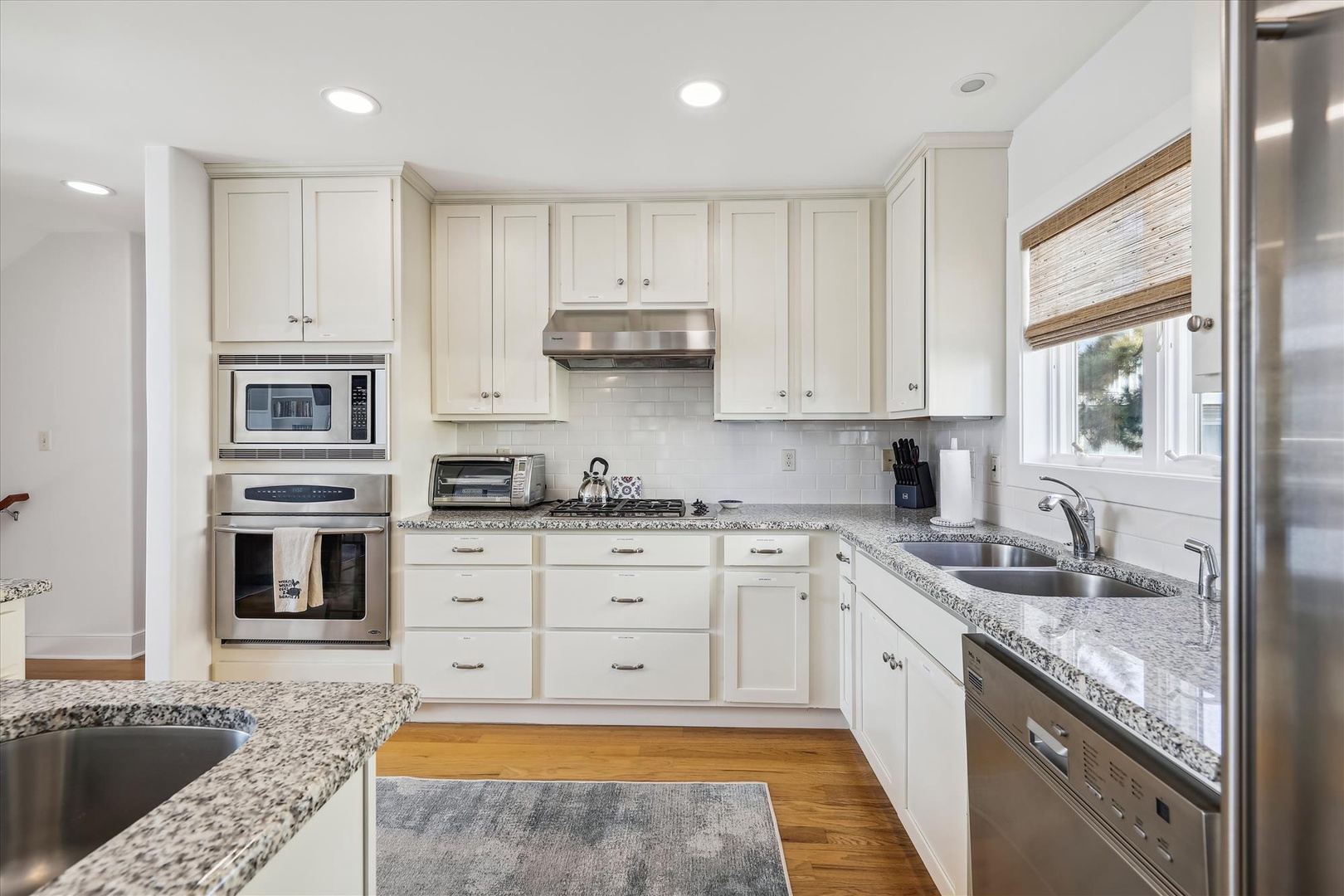 Step into your gleaming chef's kitchen with sleek granite counters, stainless appliances, and crisp white cabinetry—everything you need to whip up meals and make memories.