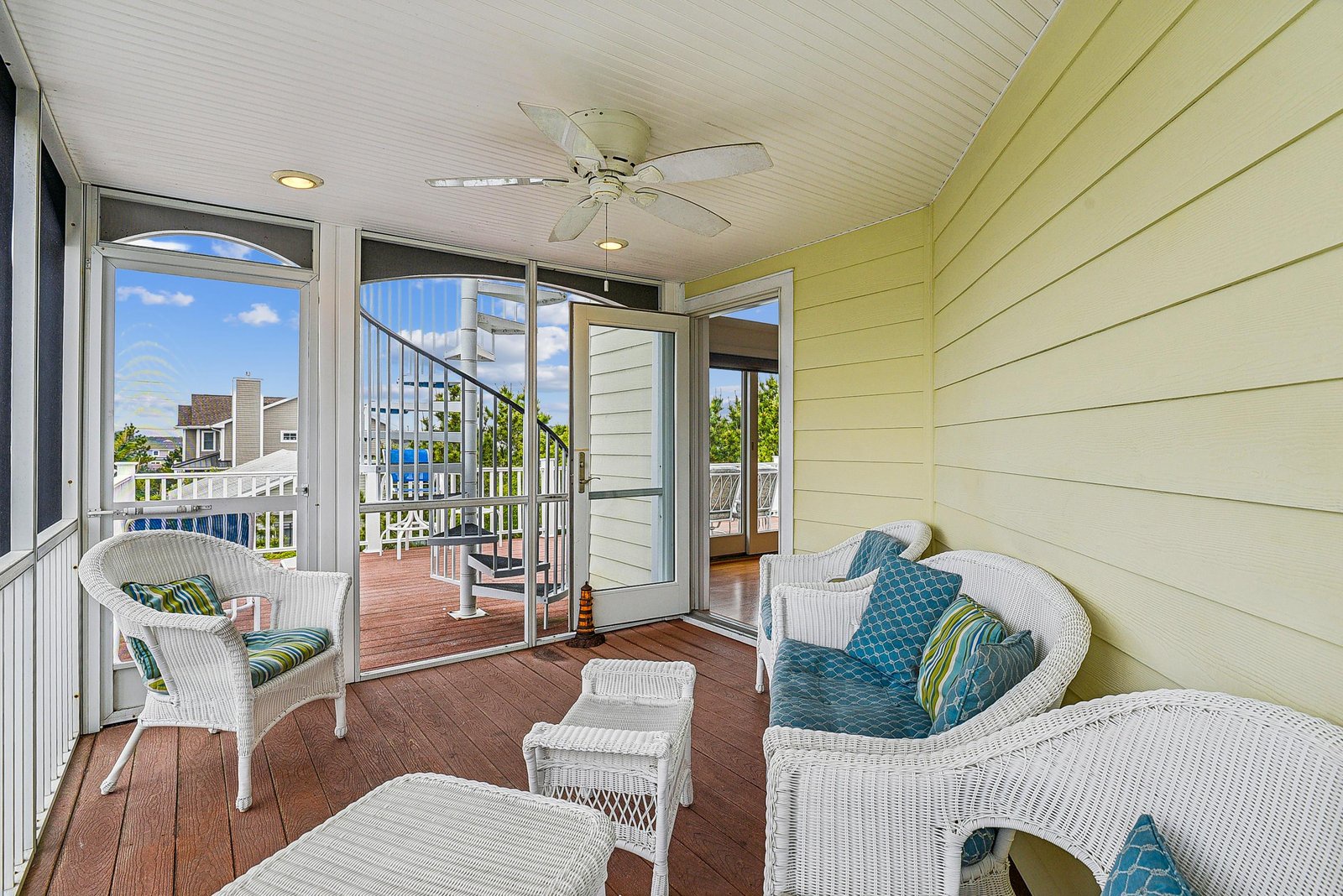 Step onto your private screened porch with comfy wicker seating and a ceiling fan—perfect for morning coffee or evening breezes while enjoying the neighborhood views.