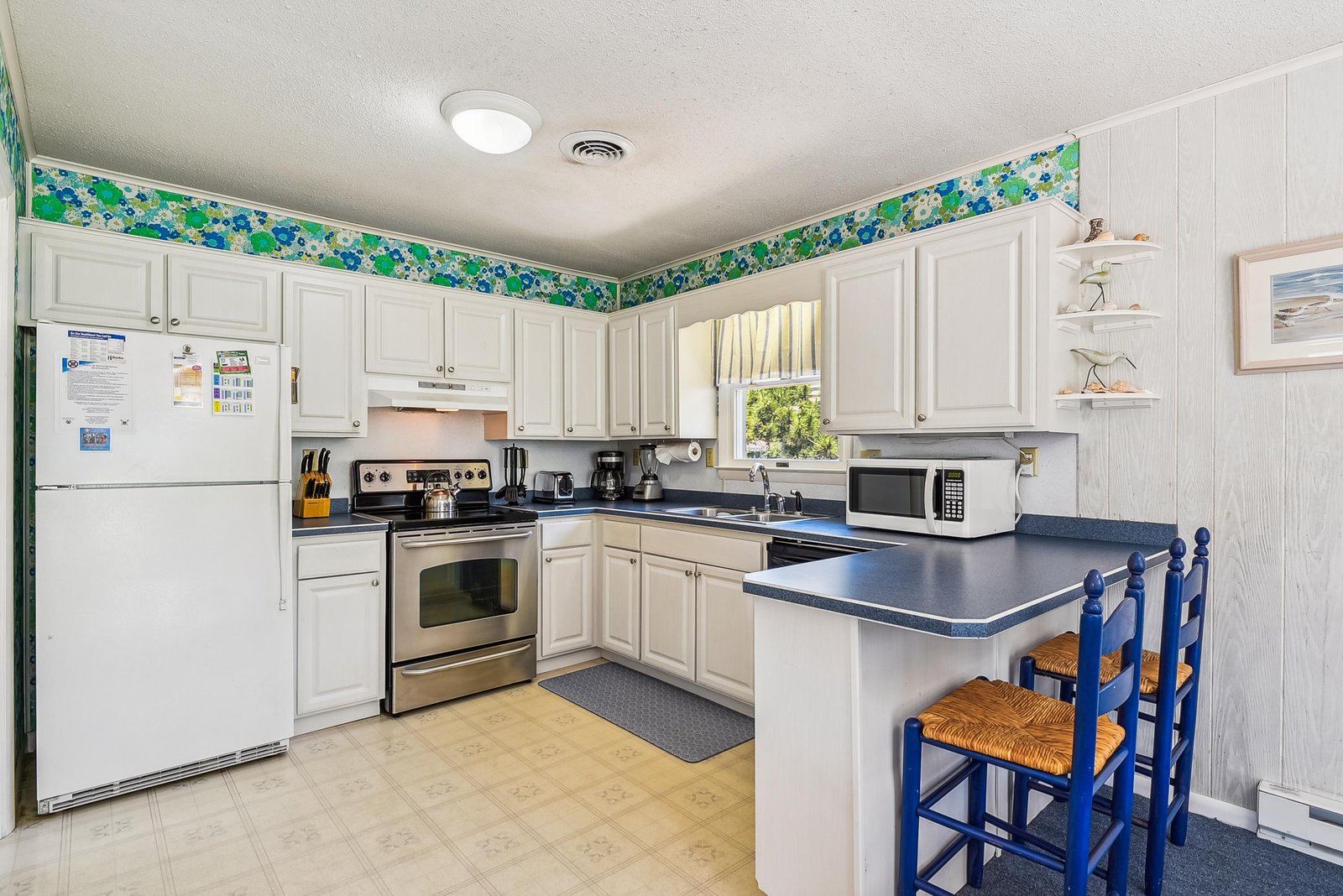 Your fully equipped kitchen awaits with everything you need to whip up family meals—bright windows, ample counter space, and a cozy breakfast bar where you can sip your morning coffee.