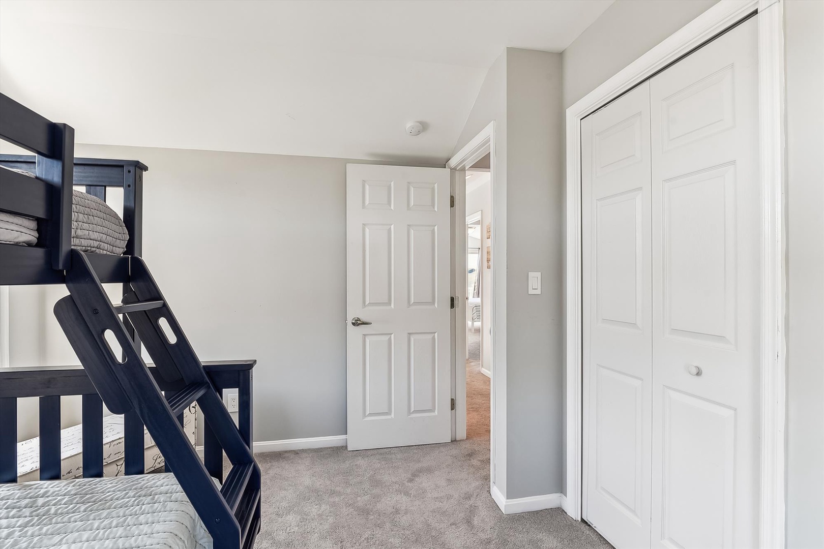 Your bright, carpeted bedroom offers a cozy bunk bed and plenty of closet space. Soft neutral tones create a calm, restful atmosphere where you can unwind after a busy day.