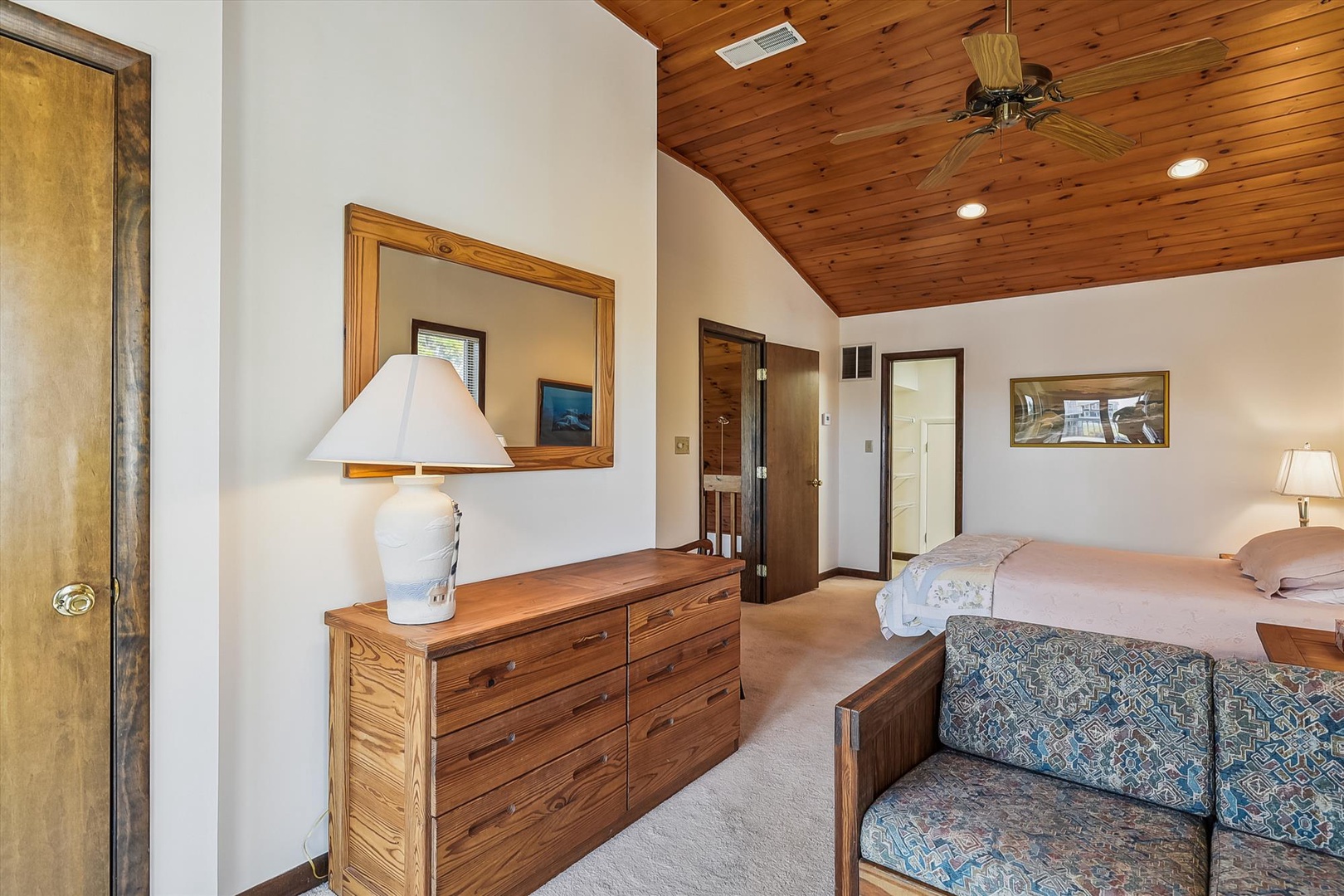 Relax in your charming bedroom with a beautiful wood-planked cathedral ceiling, cozy seating, and a comfortable queen bed waiting to welcome you home after your adventures.