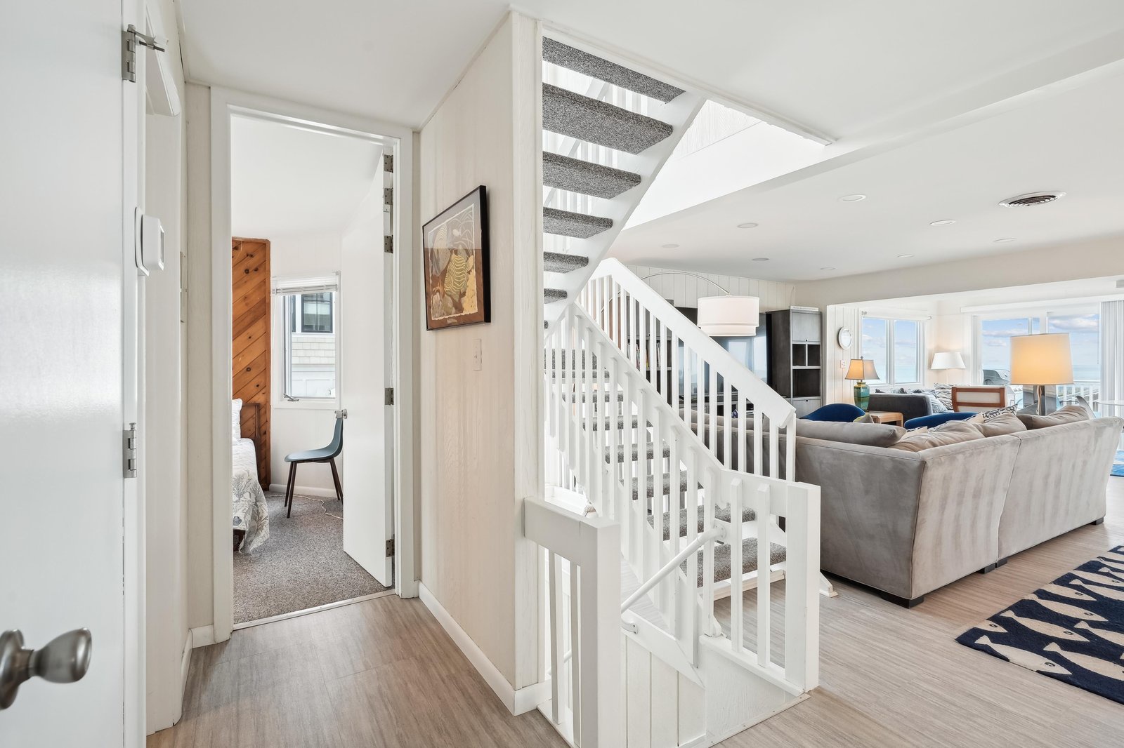 Bright, airy spaces welcome you with coastal-inspired design. From your entryway, you'll glimpse comfortable living areas and bedrooms—everything flows naturally, making your vacation home feel both spacious and effortlessly inviting.