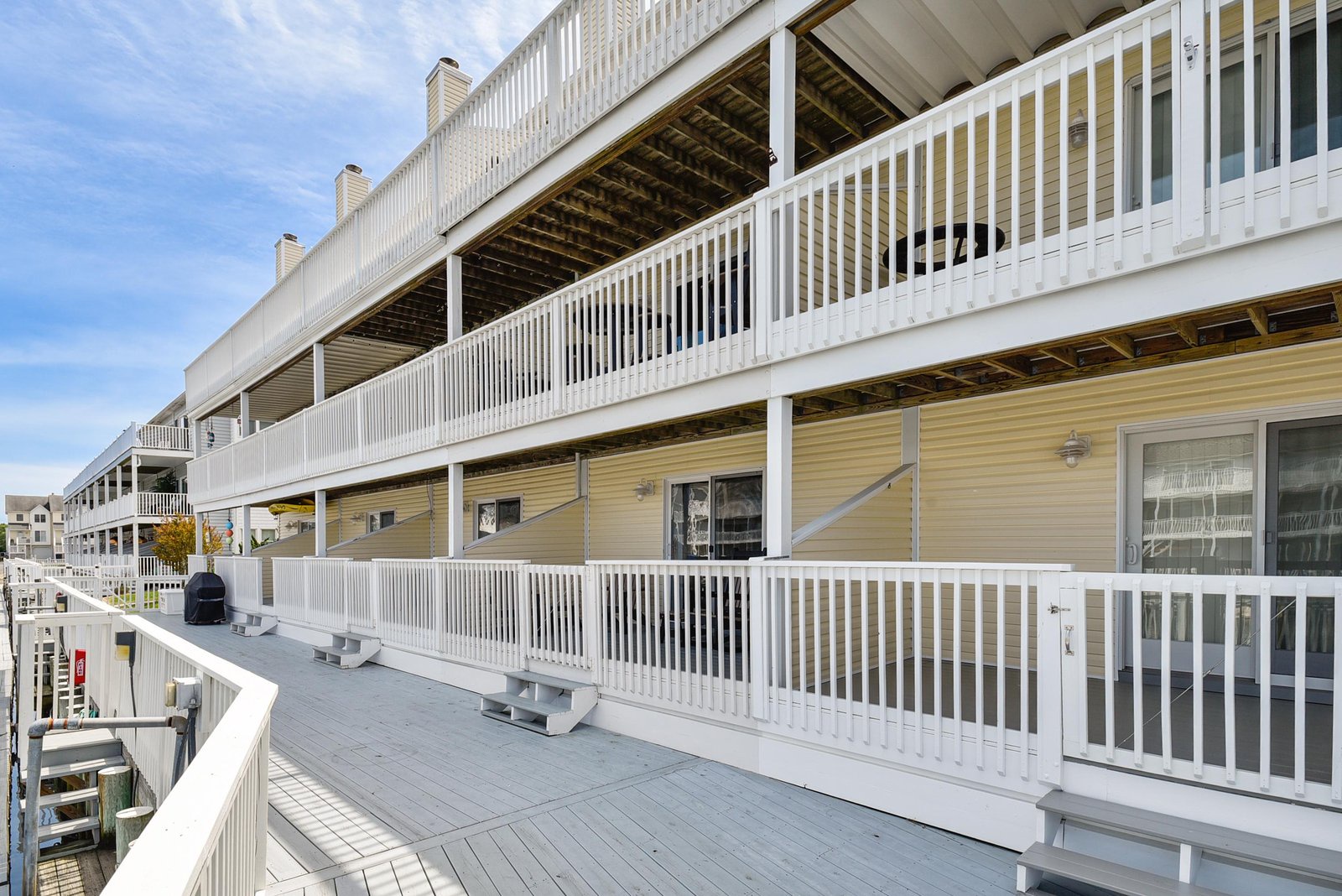 Step out onto your private deck with crisp white railings and plenty of space to soak in the coastal air—perfect for morning coffee or evening relaxation.