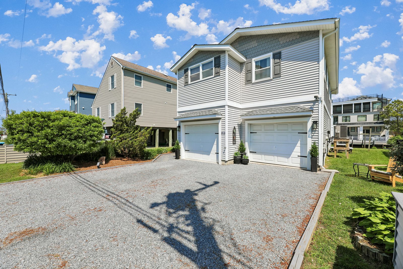 Welcoming coastal rental homes with private garages and landscaped grounds nestled in a quiet residential neighborhood, just steps from beach access.