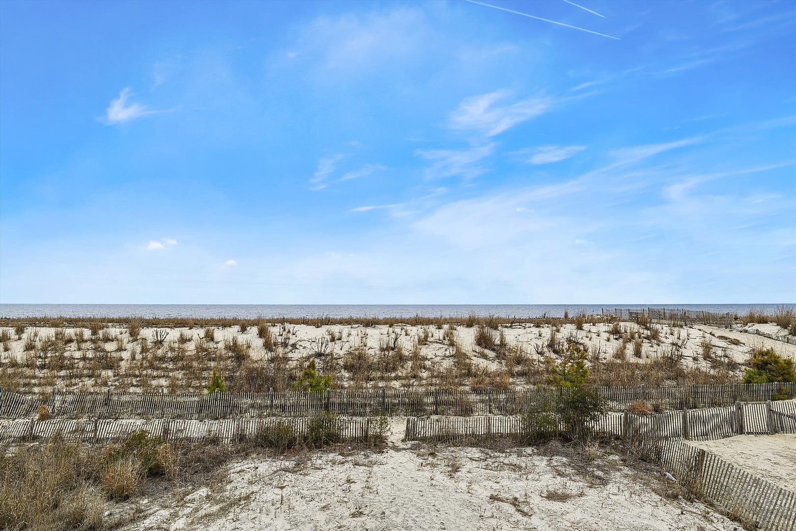 Coastal dunes and sea views define this beachfront property's scenic location, offering a peaceful retreat near the water.