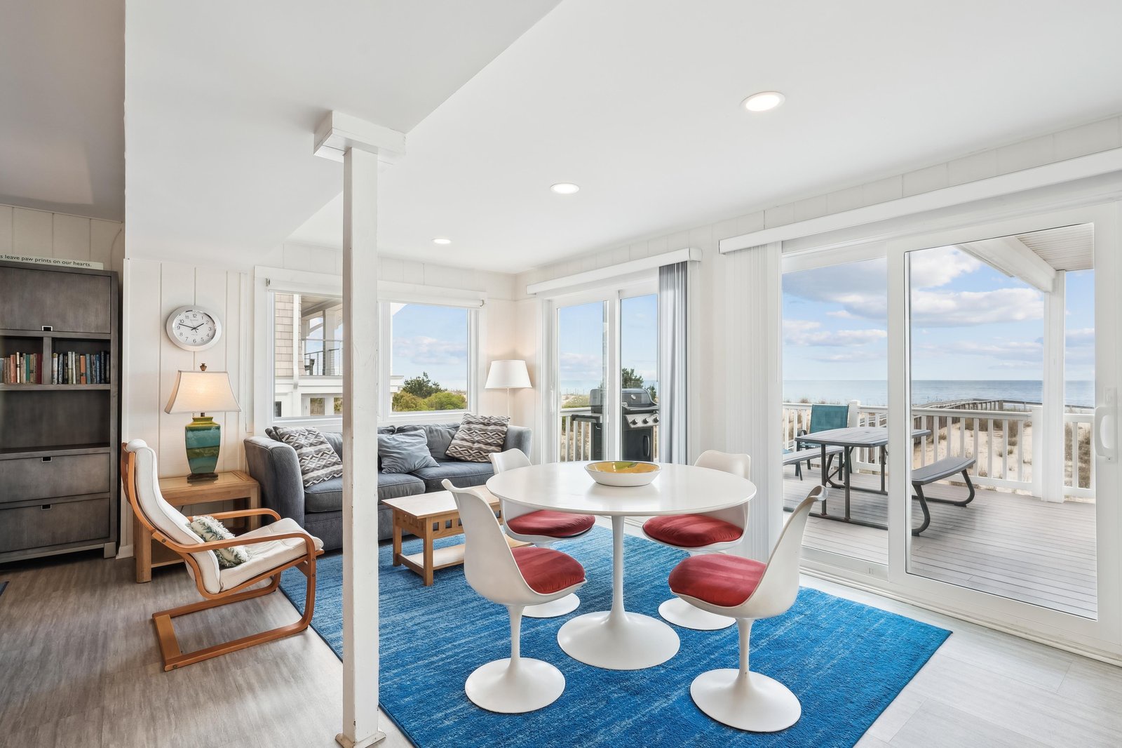 Picture yourself relaxing in this bright, coastal-inspired living space, where sweeping ocean views pour through the glass doors and invite you to unwind in style and comfort.