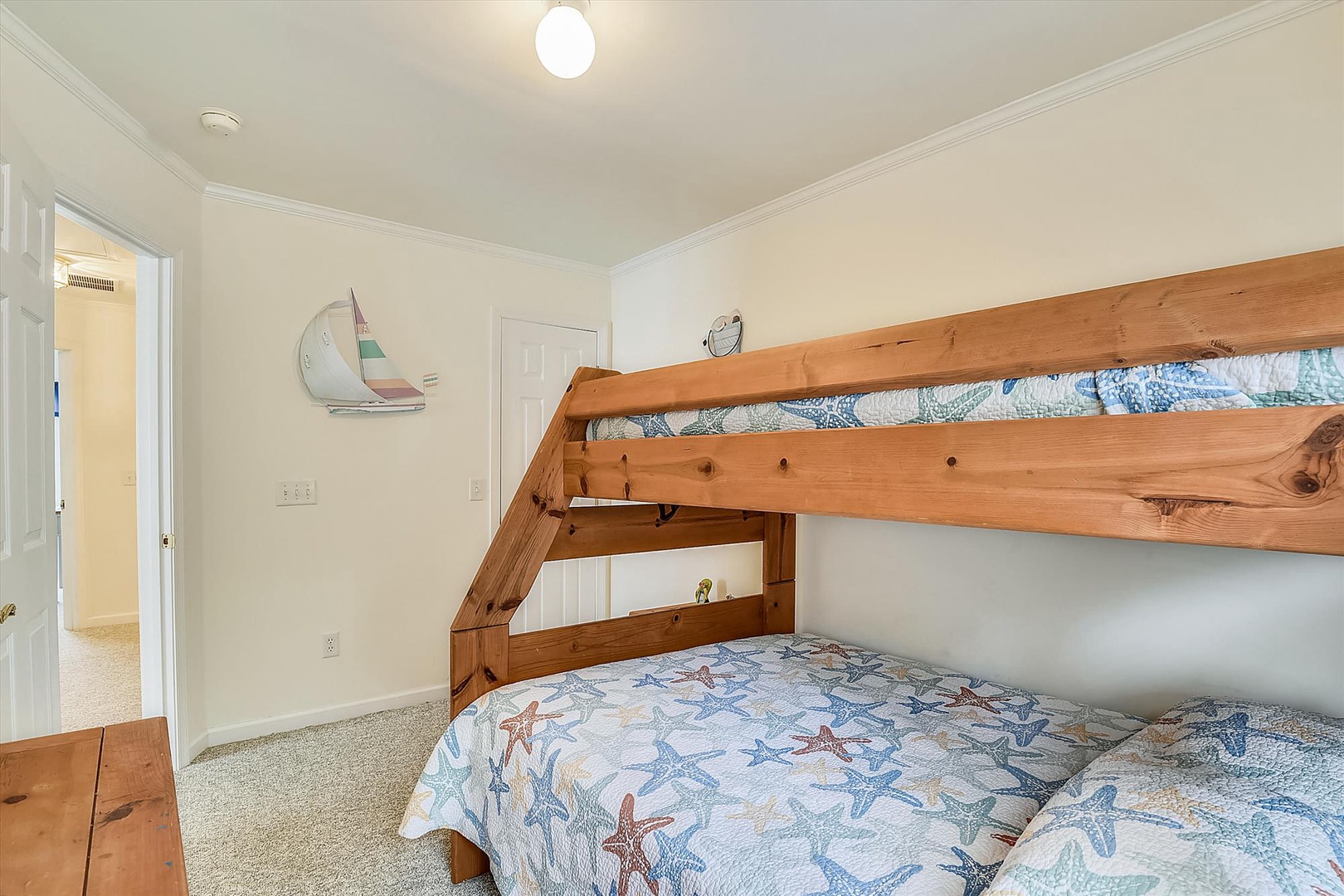 Your beach-themed bedroom features a sturdy wooden bunk bed with coastal quilts, perfect for families traveling together. Bright and cheerful, this space makes everyone feel right at home.
