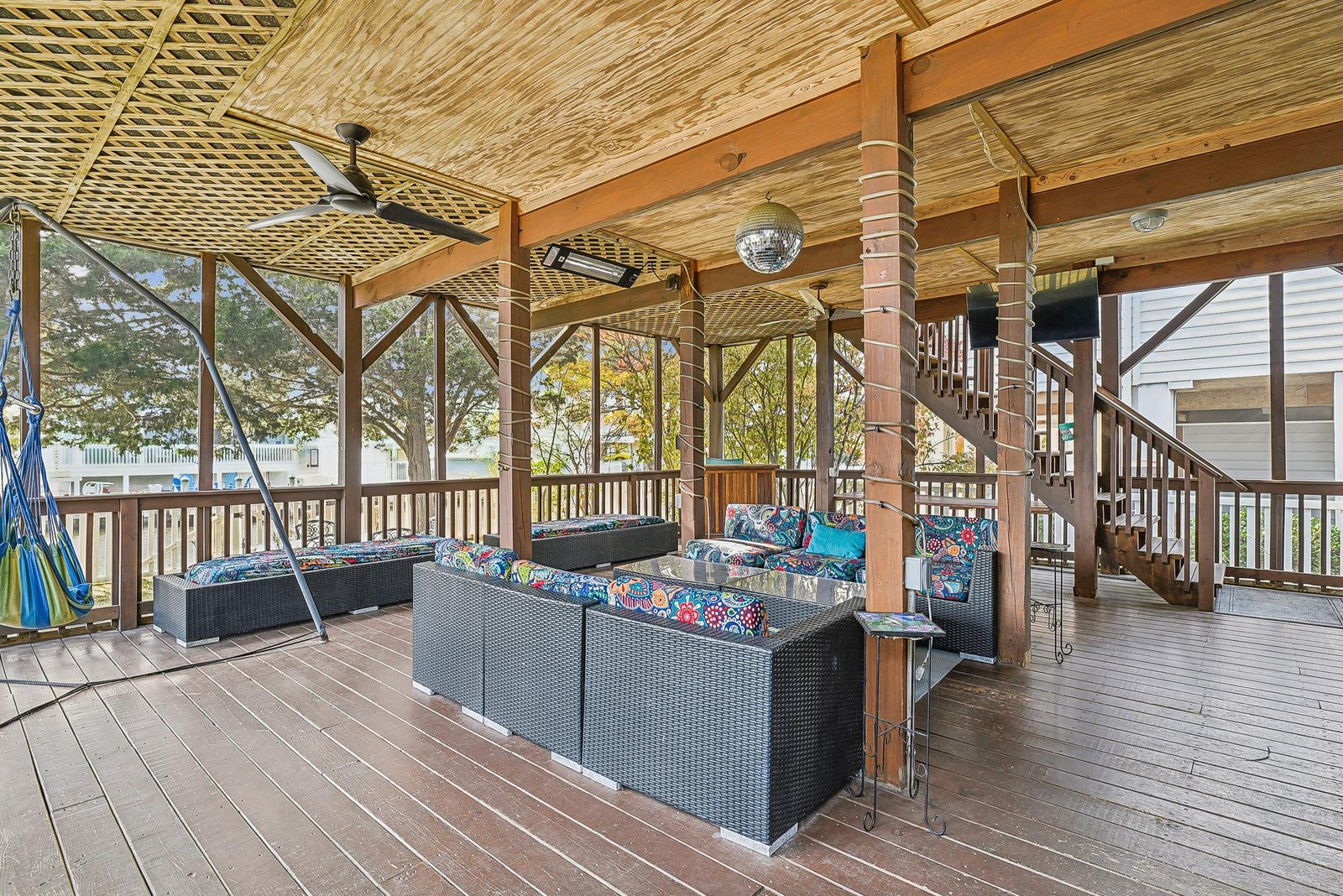 Settle into this breezy screened porch with comfy seating, a ceiling fan, and natural lake views—your perfect spot to unwind with morning coffee or evening conversation.