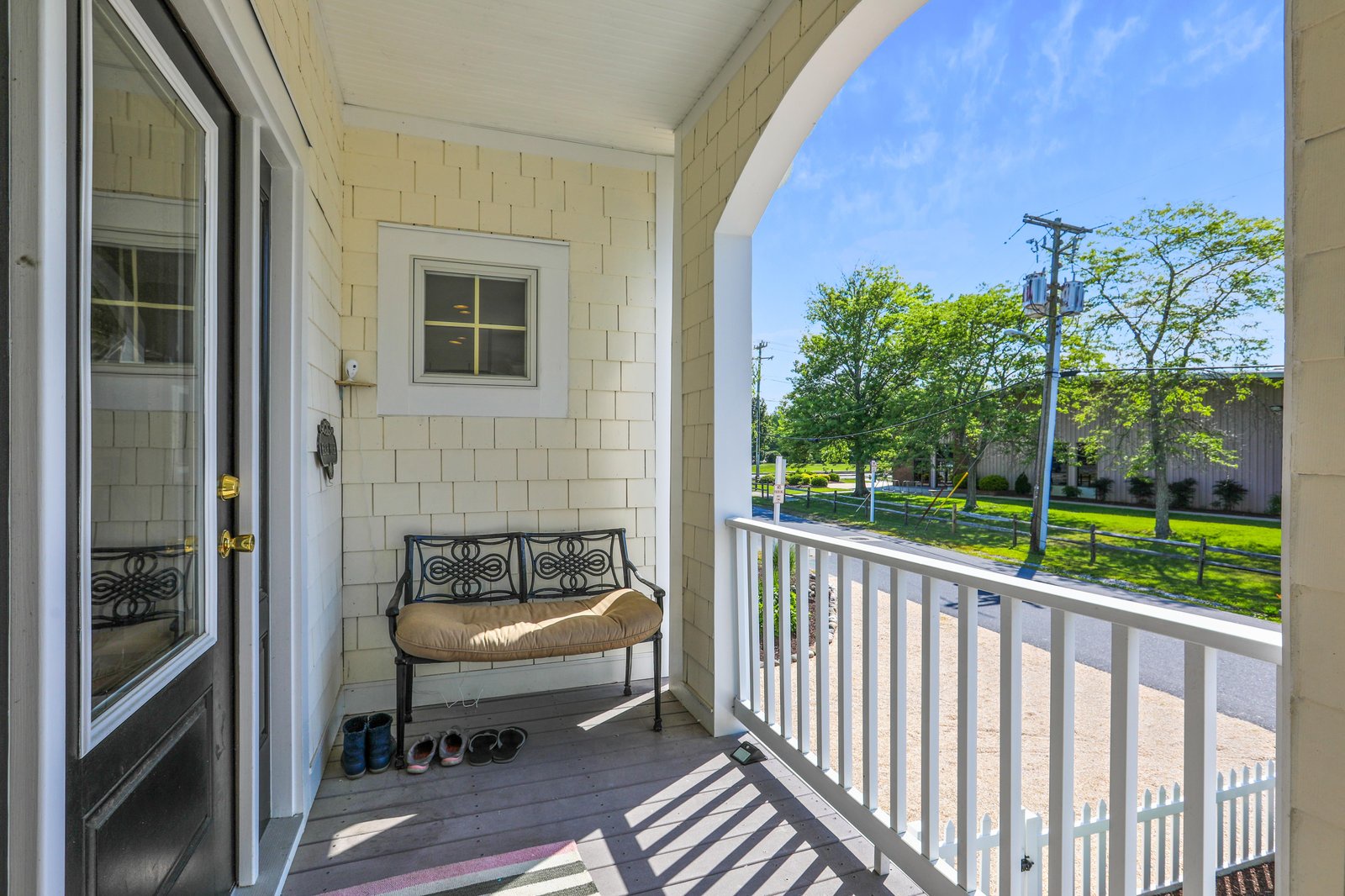 Step out onto your private porch and breathe in the fresh air. A welcoming bench invites you to relax with morning coffee or evening conversation, while tree-lined views and peaceful neighborhood surroundings create your own quiet retreat.