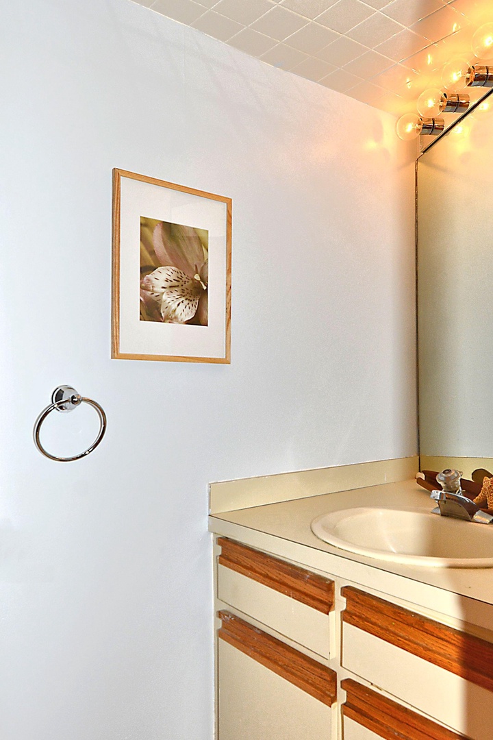 Your private bathroom offers a warm welcome with soft lighting, a spacious vanity, and thoughtful touches—perfect for unwinding after a day of exploring.