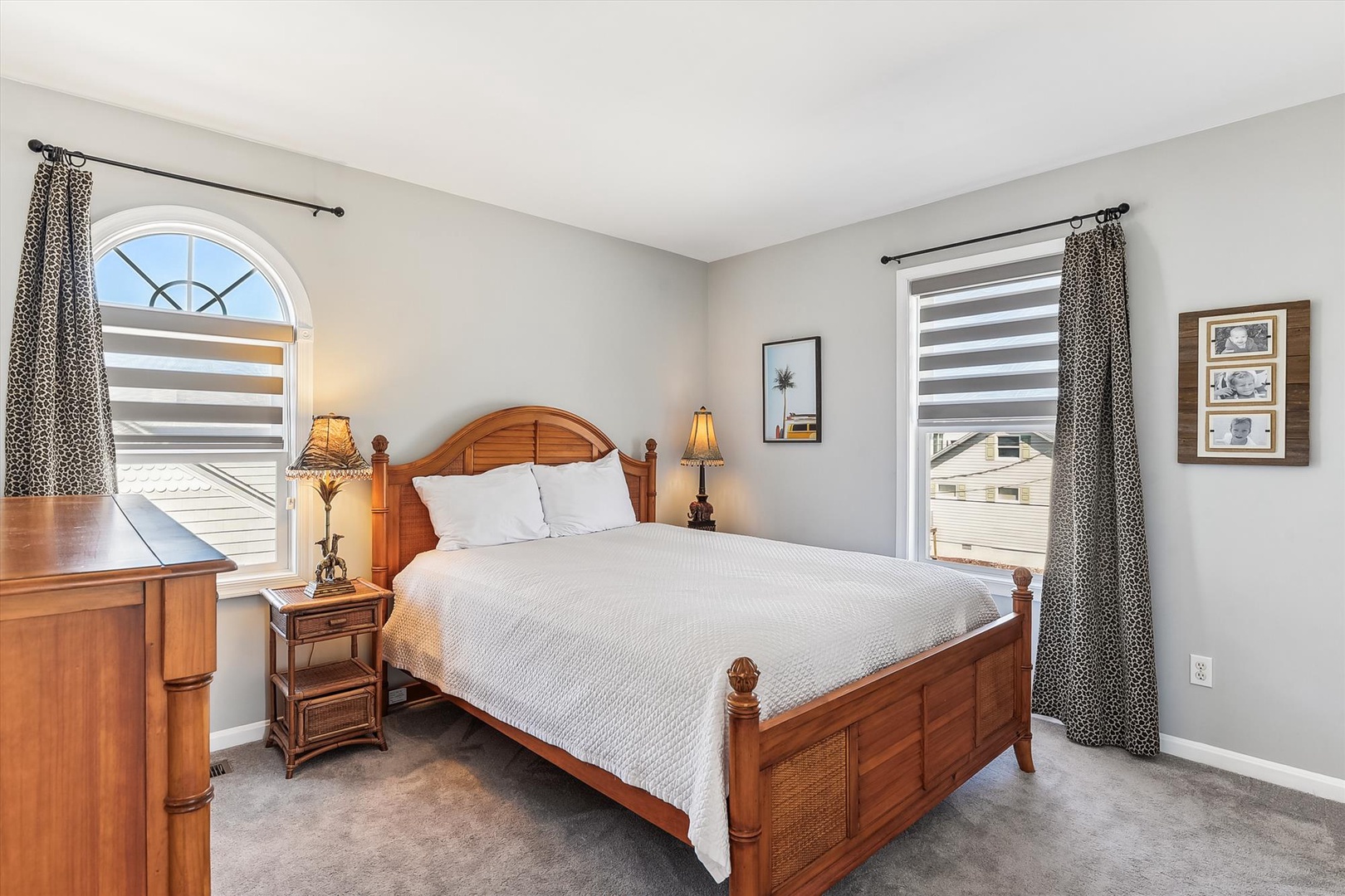 Sink into plush white linens and let natural light fill your peaceful retreat. The elegant wood furnishings and soft carpeting create a warm, inviting space where you'll truly unwind.
