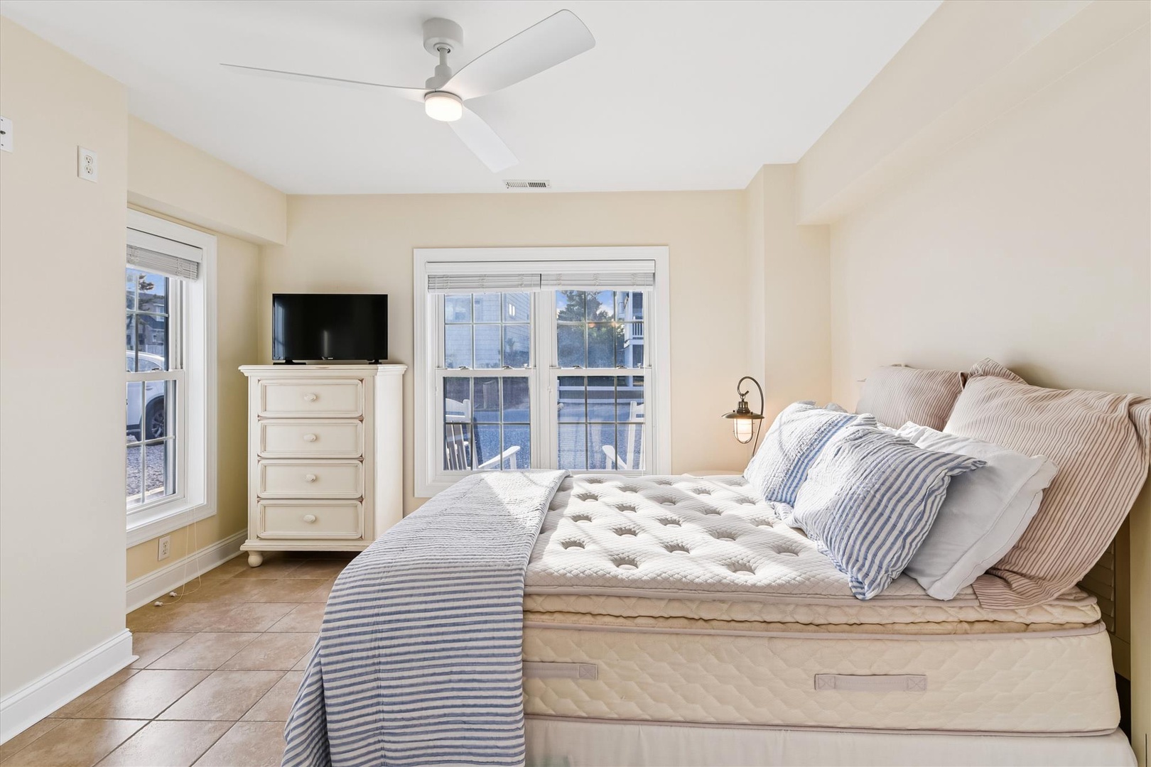 Unwind in your serene bedroom, where soft coastal tones and gentle natural light create the perfect retreat after a day of exploring nearby attractions.