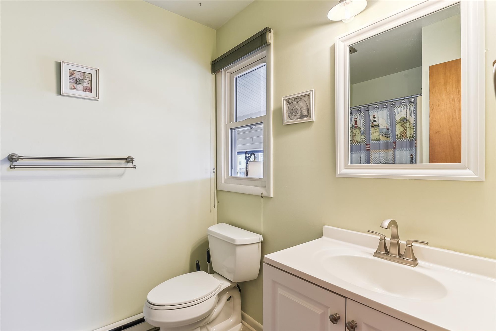 Freshen up in this spotless bathroom with its clean lines and natural light. You'll appreciate the fresh towels and simple, functional design that makes your morning routine feel effortless.