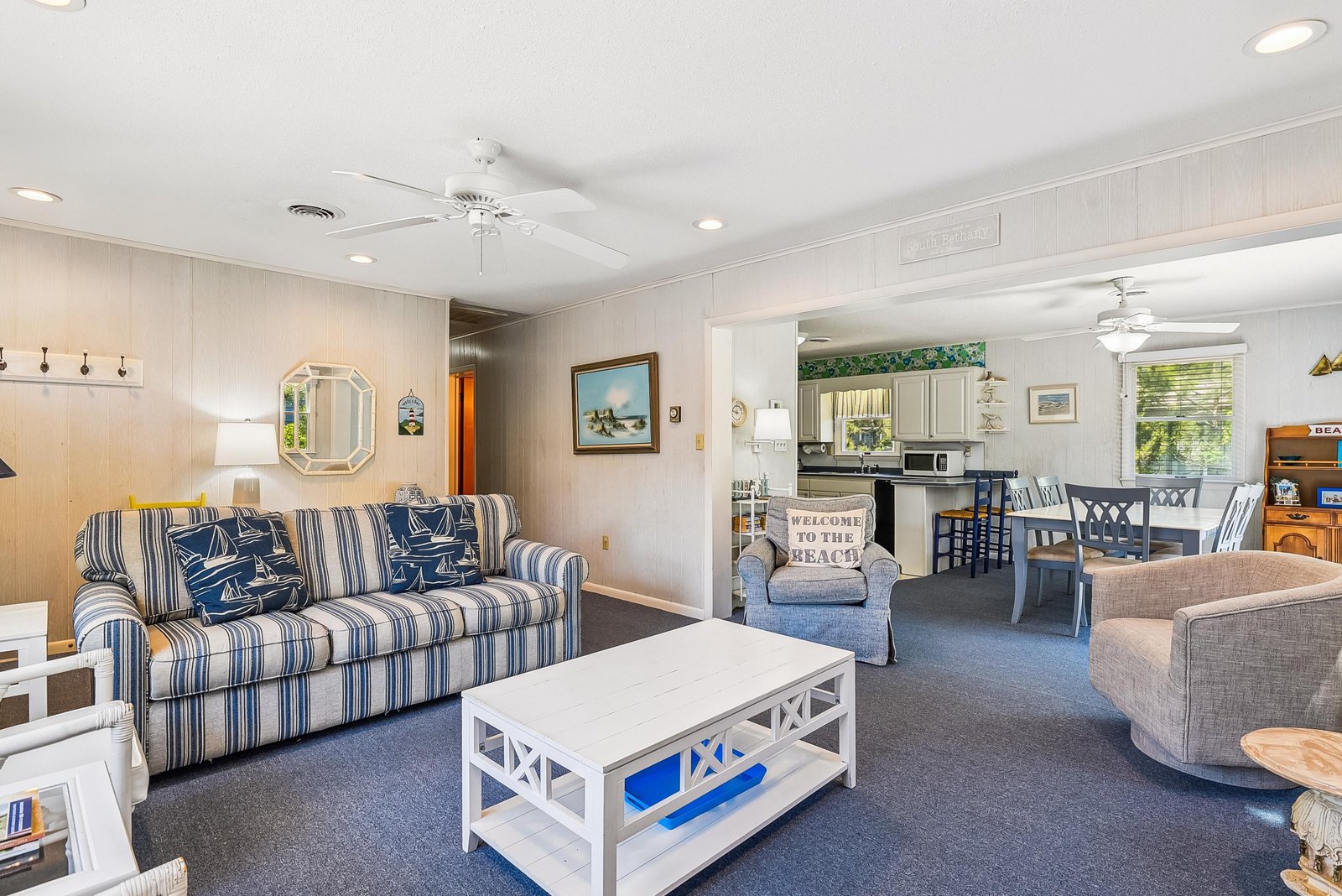Step into your breezy beach retreat, where nautical-inspired furnishings and an open layout invite you to kick off your shoes and settle in for a relaxing coastal getaway.