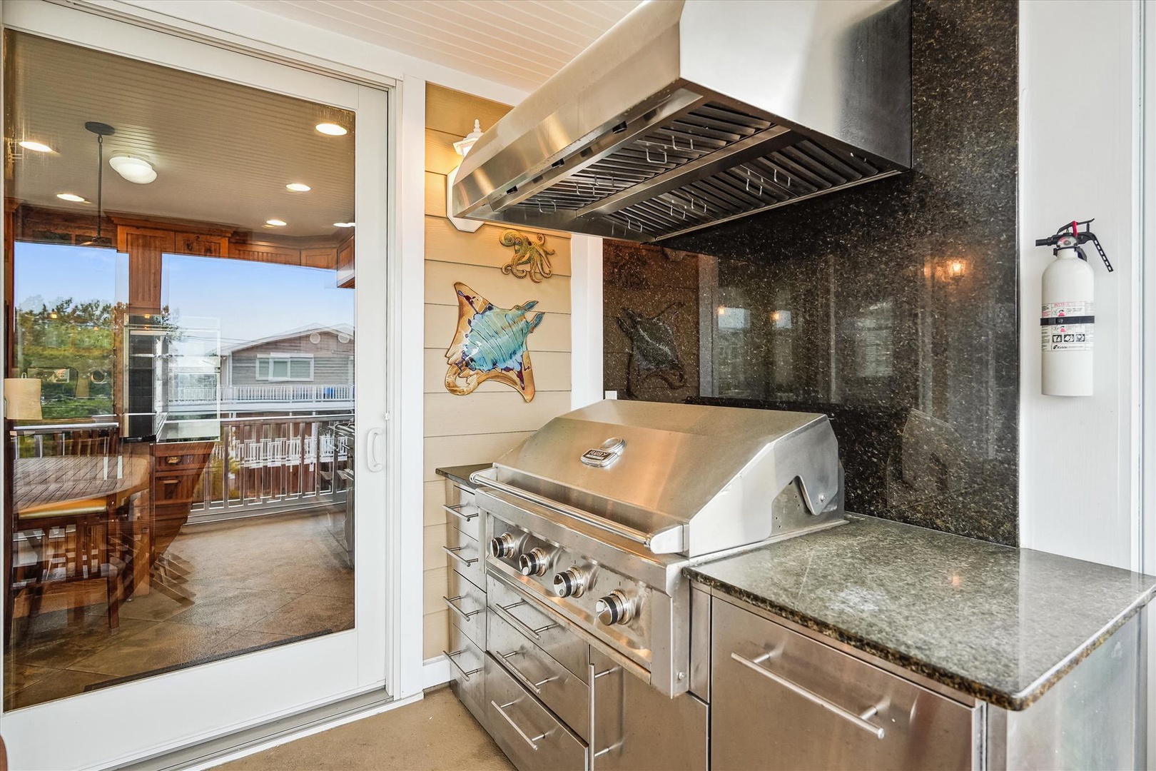 Fire up the grill in your private outdoor kitchen, complete with stainless-steel appliances and granite countertops, where you can cook while soaking in views of the water and neighborhood charm.