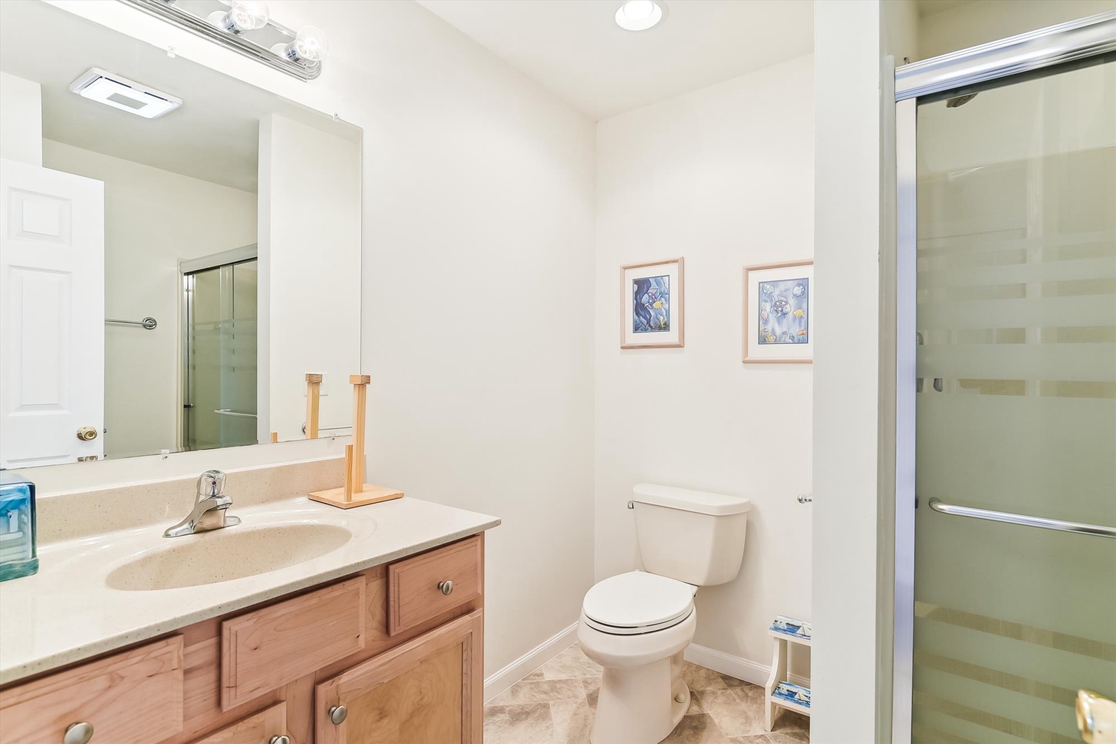 Your private bathroom features a spacious shower, soothing neutral tones, and thoughtful touches that make freshening up a pleasure.