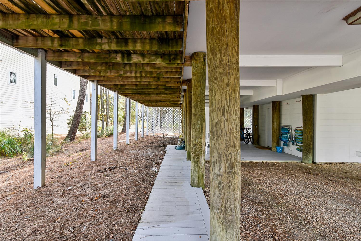 Covered walkway leads to the property entrance with convenient ground-level access and parking area.