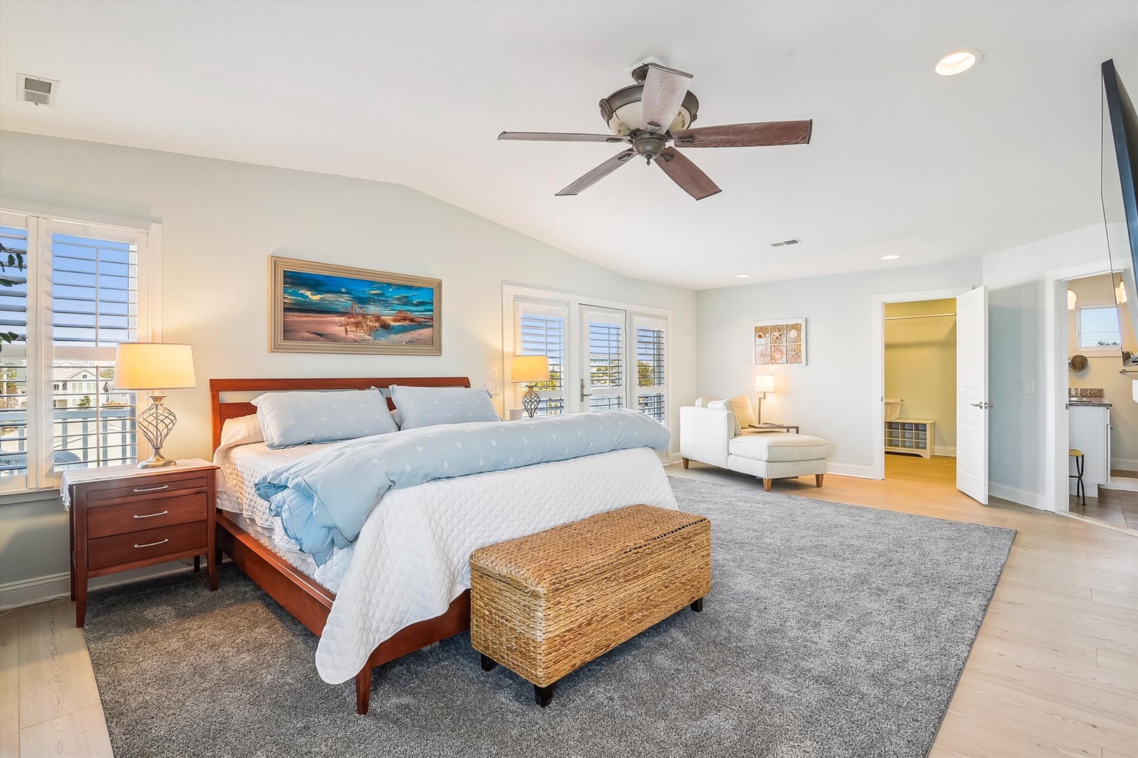 Drift off in your spacious master bedroom with coastal art, plush bedding, and a private seating nook that invites total relaxation.