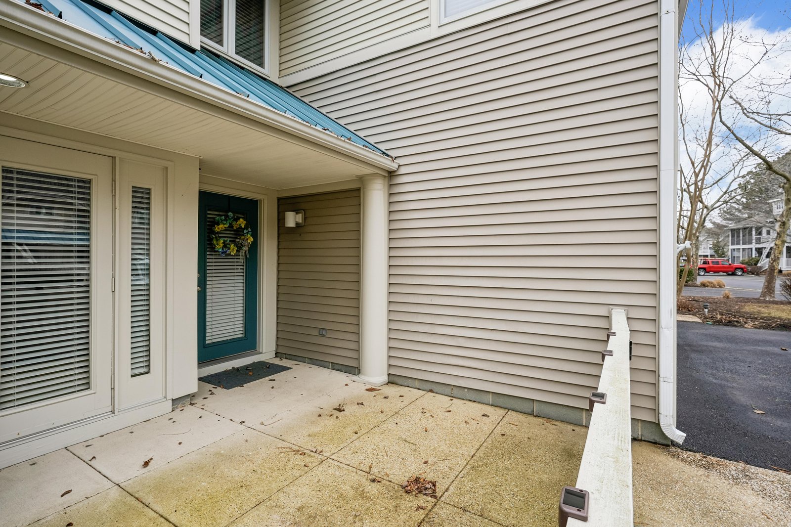 A welcoming front entrance with covered porch leads to your private rental, situated in a quiet residential neighborhood with nearby street parking.