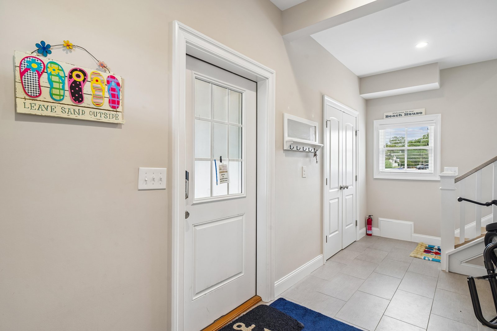 A bright, welcoming entryway with cheerful beach-themed decor sets the tone for your coastal getaway, with convenient hooks and closet space ready for your arrival.