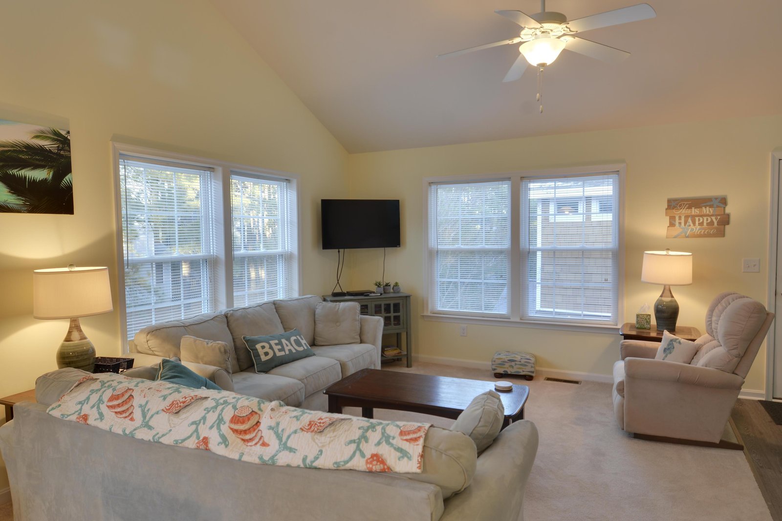 Gather with your loved ones in this bright, welcoming living room designed for relaxation. Sink into plush seating under vaulted ceilings and soft natural light—your home base for beach-day stories and evening movies.