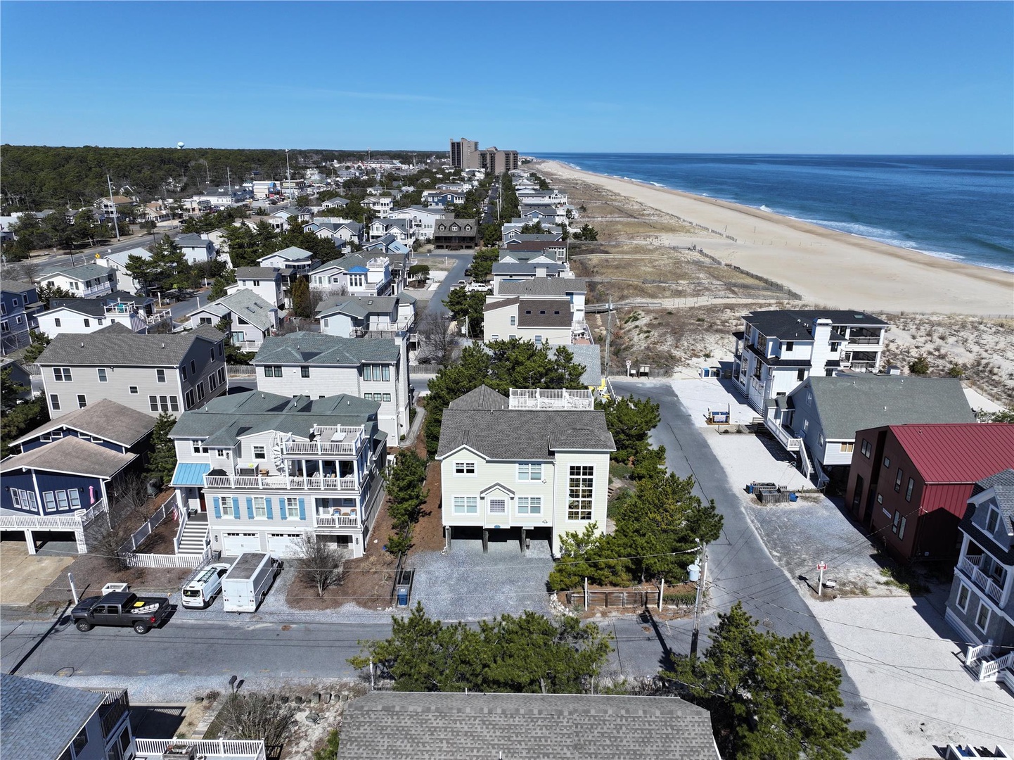 Aerial view showcasing the beachfront community with pristine sandy shores and coastal residential architecture stretching along the oceanfront neighborhood.