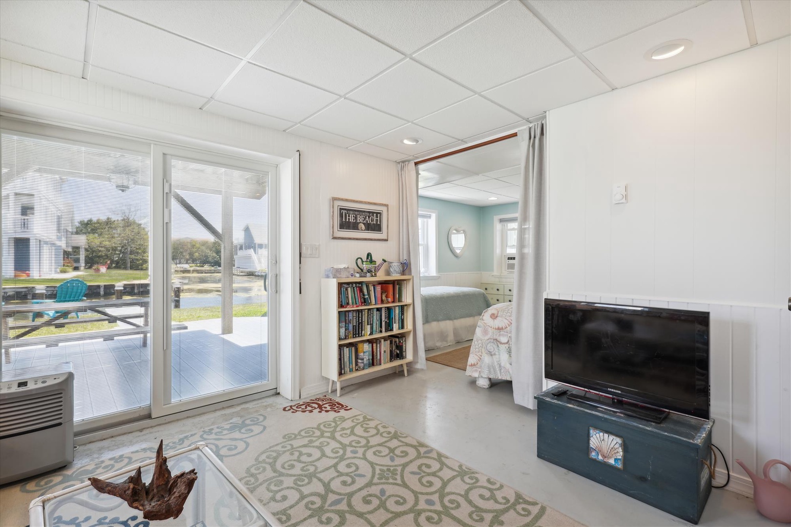 Step into your coastal retreat where a bright living area opens to a private deck with pool views. Beach-inspired decor and thoughtful touches invite you to unwind after sun-soaked days.