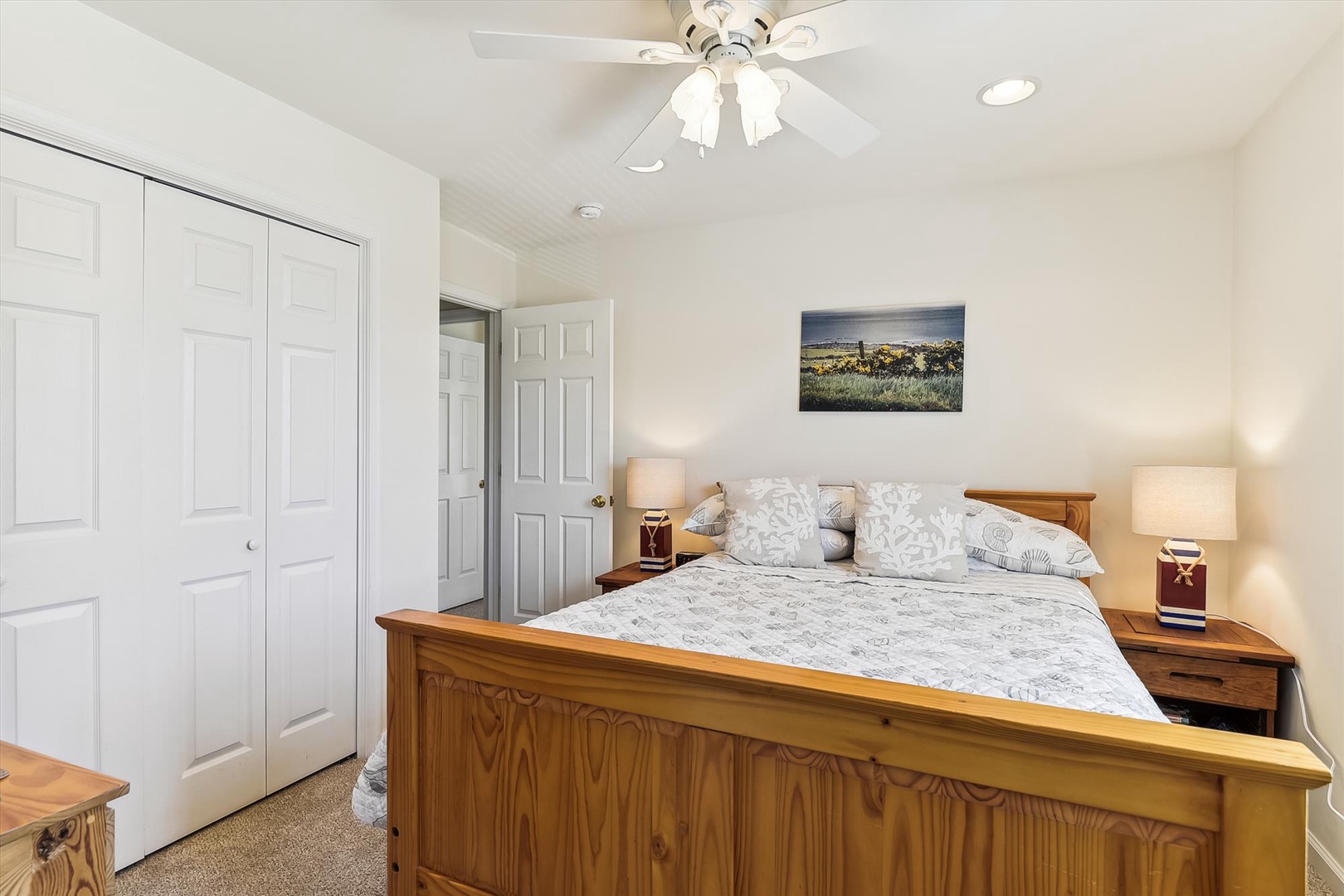 Unwind in your spacious bedroom featuring a plush bed, warm wood furnishings, and soft lighting that creates the perfect retreat after a day of adventure.