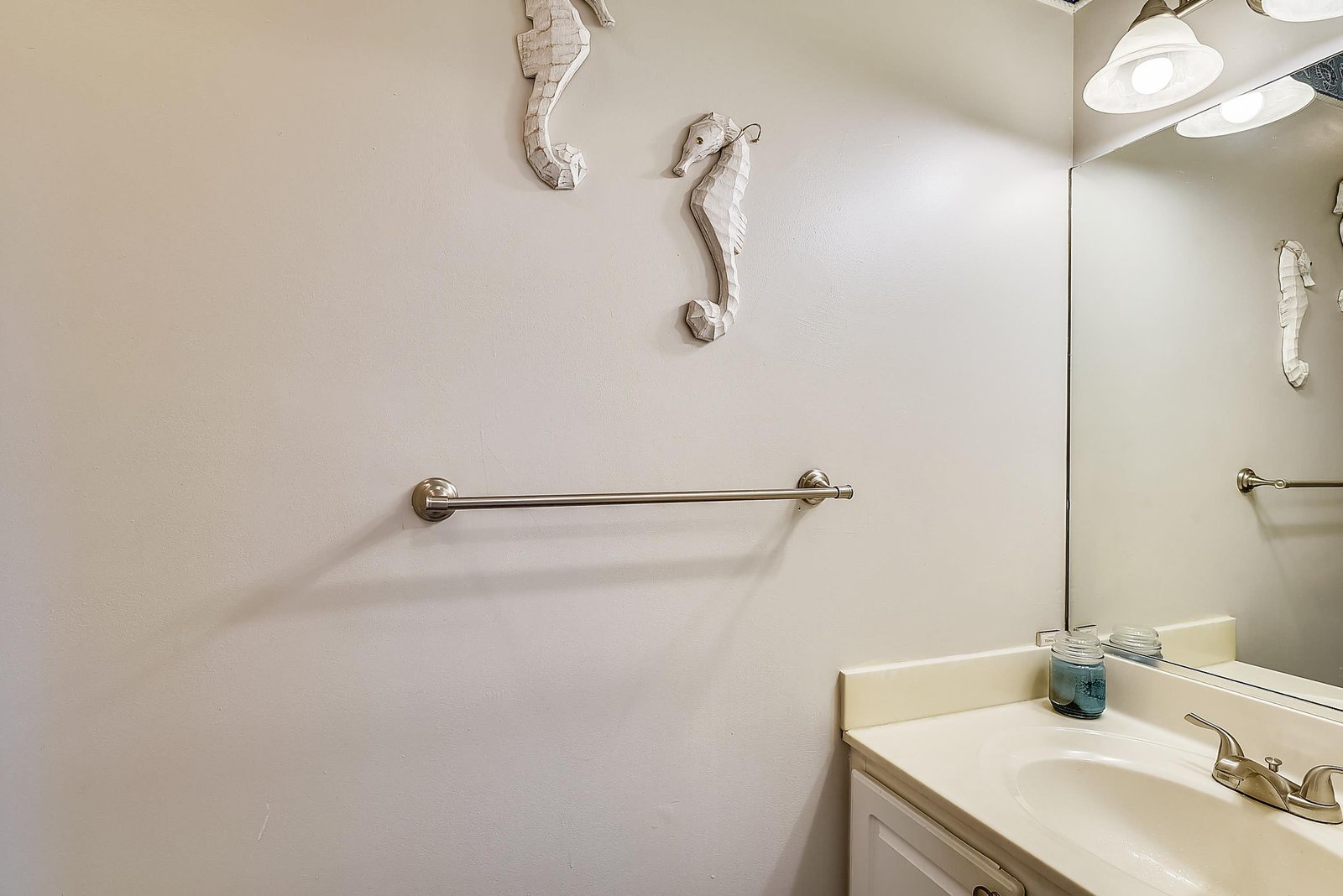 Your clean, coastal-themed bathroom features charming seahorse decor and a vanity stocked with essentials to help you settle in comfortably.