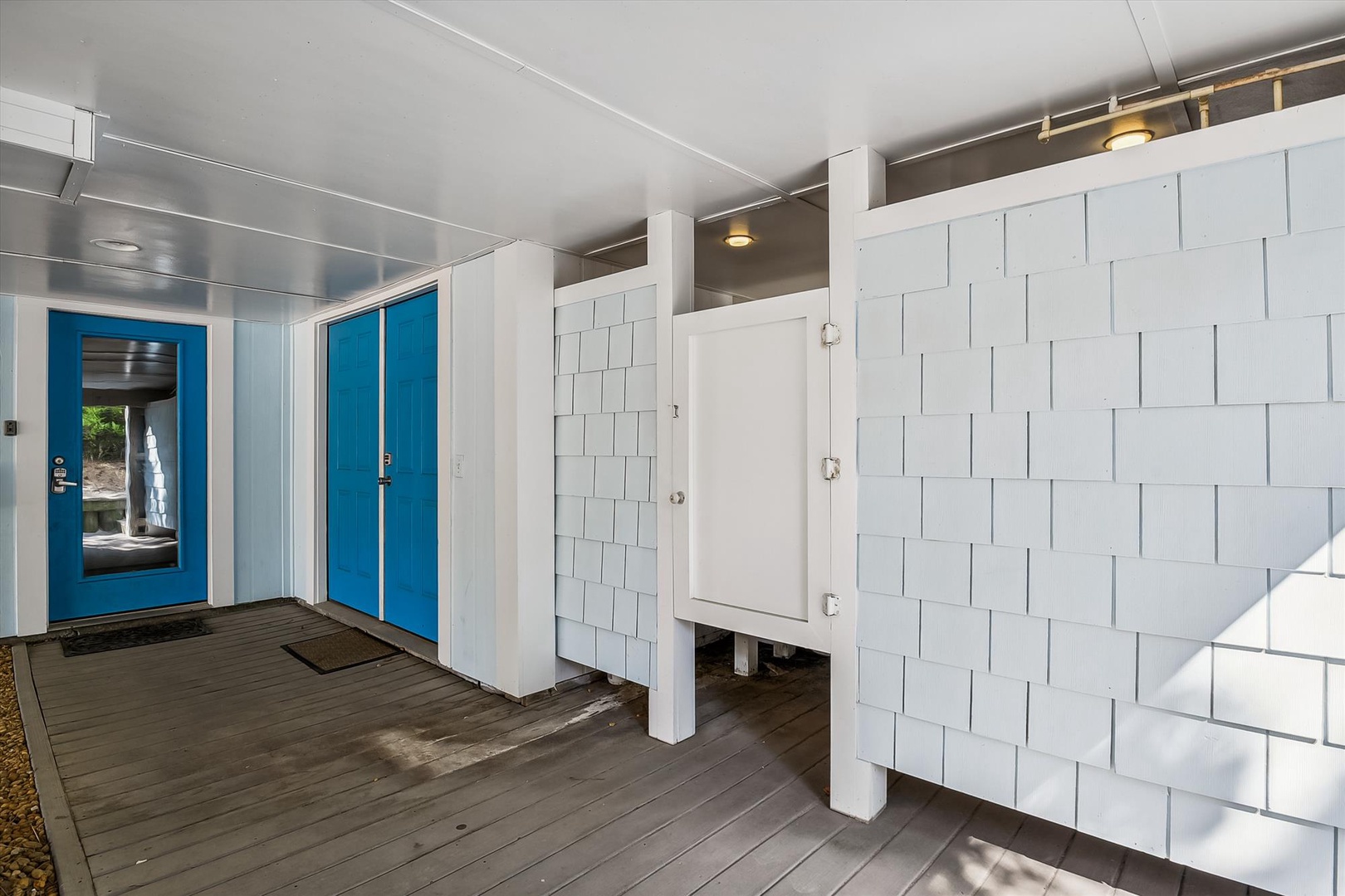 Bright blue doors and modern white paneling create a clean, contemporary entrance to the property—welcoming and easy to find when you arrive.