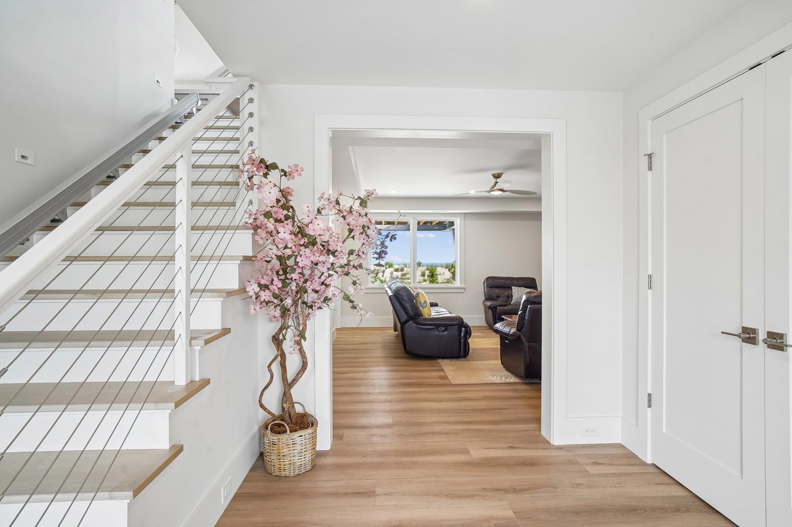 Step into a bright, airy space where modern design meets coastal charm. Warm wood floors guide you through light-filled rooms perfect for relaxing and unwinding.