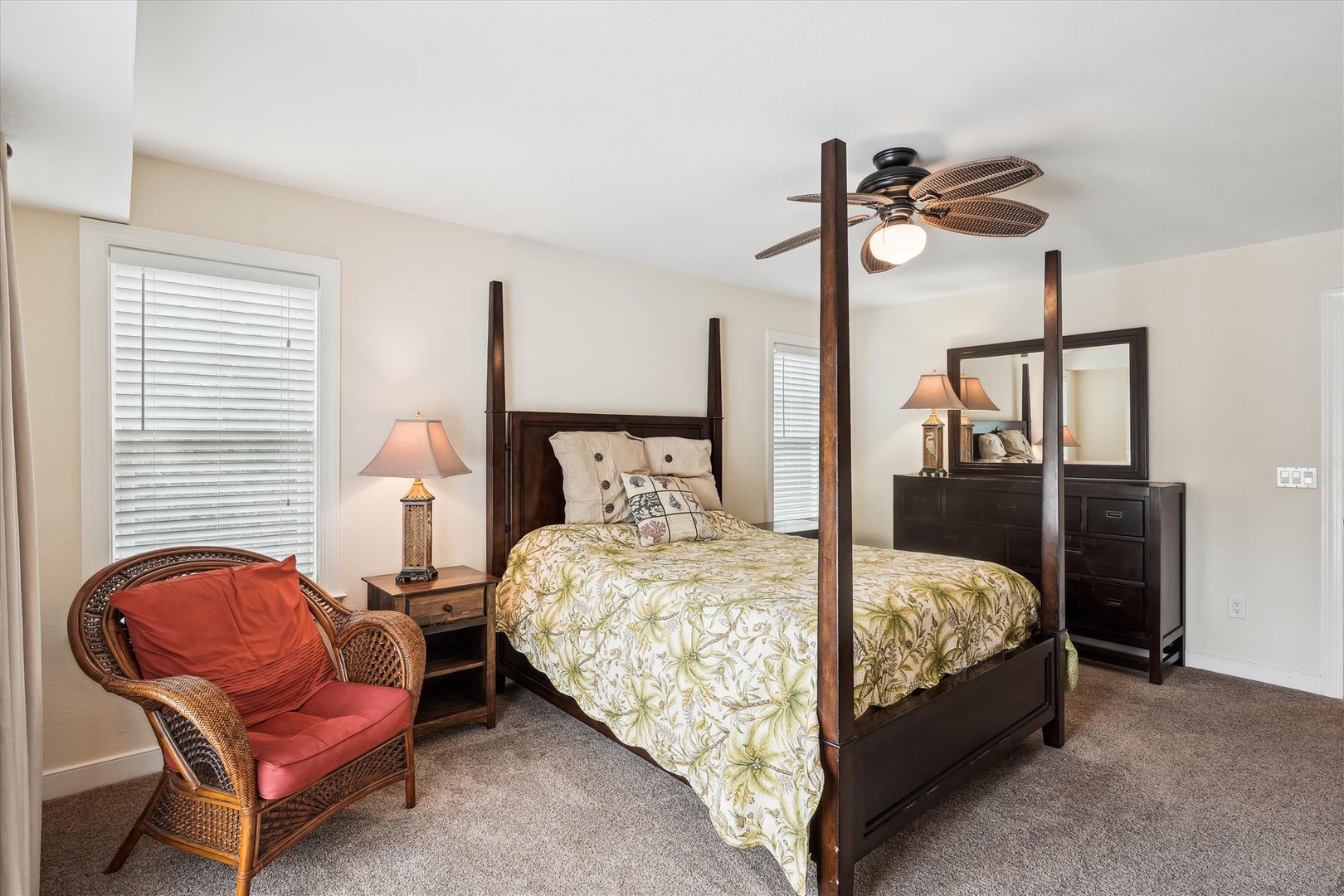 Sink into plush bedding under a unique woven-blade ceiling fan. Your spacious bedroom retreat features a statement four-poster bed, cozy reading chair, and thoughtful island-inspired touches for total relaxation.