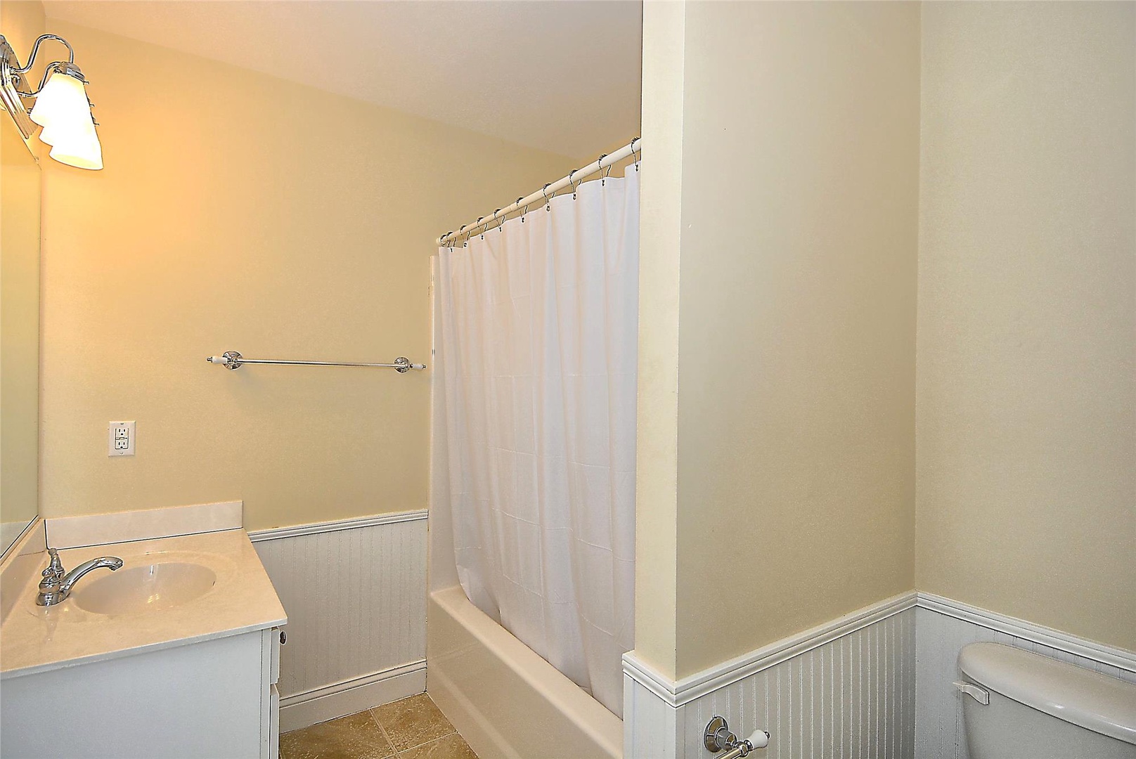 Clean, well-appointed bathroom with a shower-tub combo, perfect for refreshing after your adventures. Enjoy the fresh towels and simple comforts awaiting you.