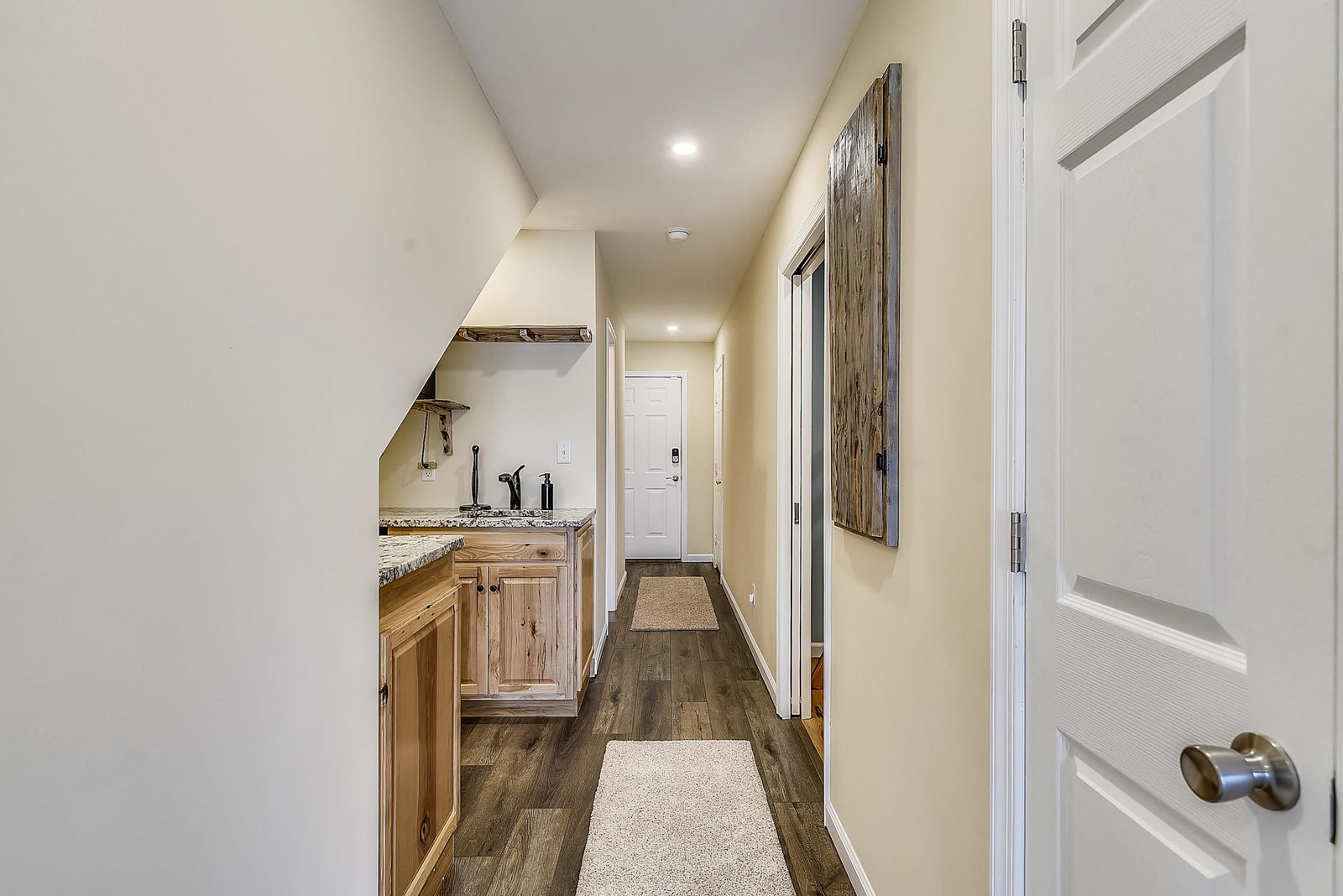 A welcoming hallway connects your private spaces with rustic wood accents and warm lighting throughout.