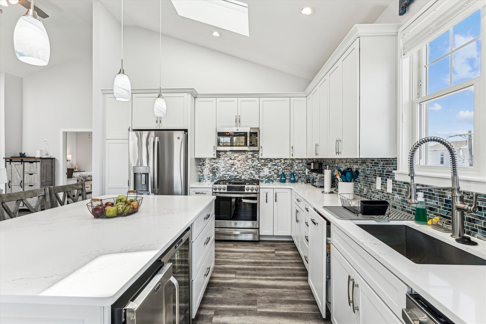 Step into your dream kitchen with sleek white cabinetry, shimmering backsplash, and top-tier appliances. Bright natural light floods in, making meal prep feel effortless and inspiring.