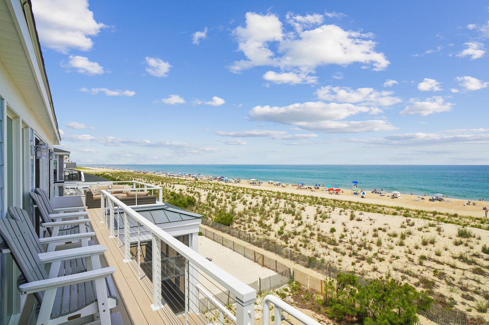 Stunning beachfront property with sweeping ocean views and direct beach access. Your private deck overlooks pristine dunes and sparkling turquoise water.