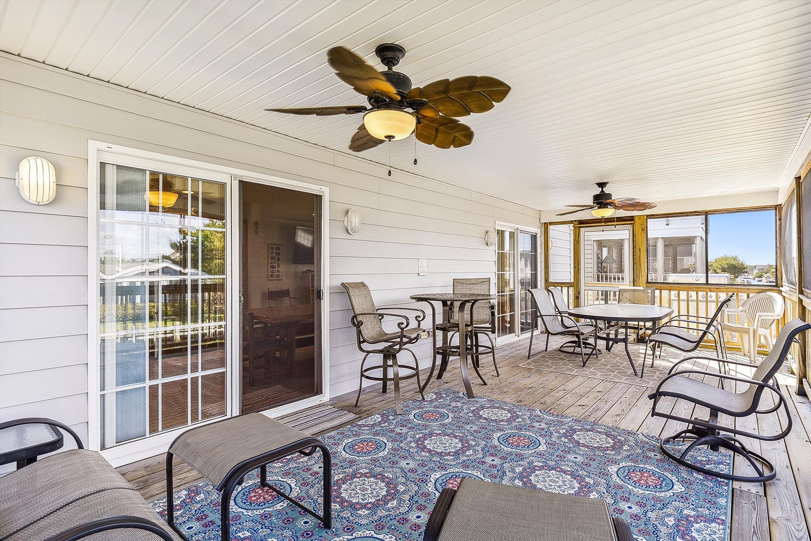 Your private screened porch offers coastal breezes and plenty of seating for morning coffee or evening cocktails, framed by peaceful water views.